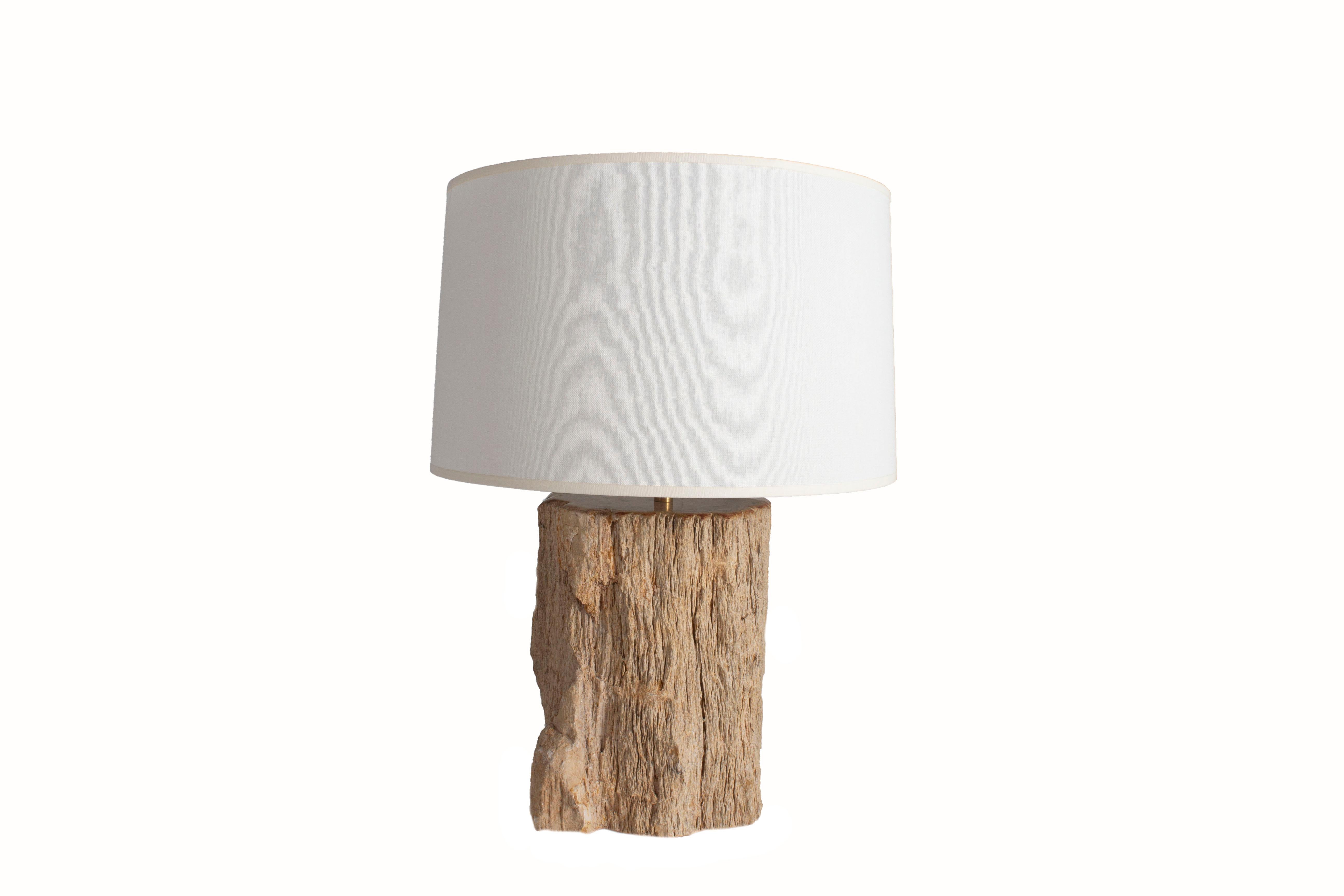 Table lamp made from petrified wood. These lamps are one of a kind and each vary slightly.

With lamp shade: H 23 x D 15.