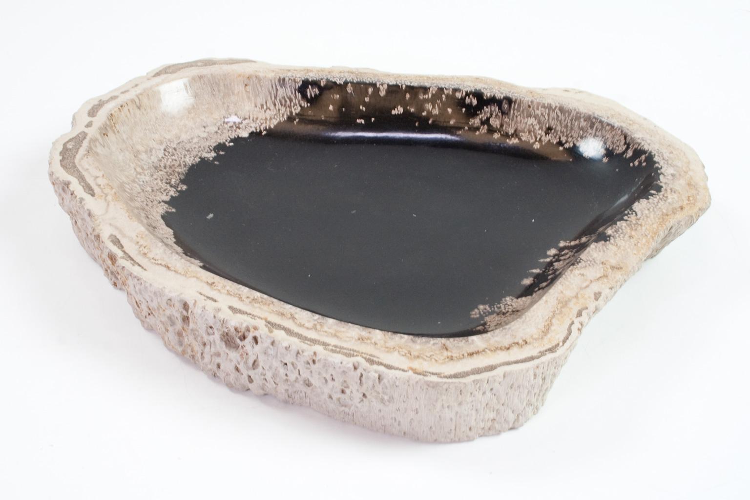 Petrified wooden bowl, smooth sanded and polished on the inside. The beige and white, outside stands out against the anthracite / charcoal, which, together with the organic shape make this an elegant item. The objects still hold the organic and