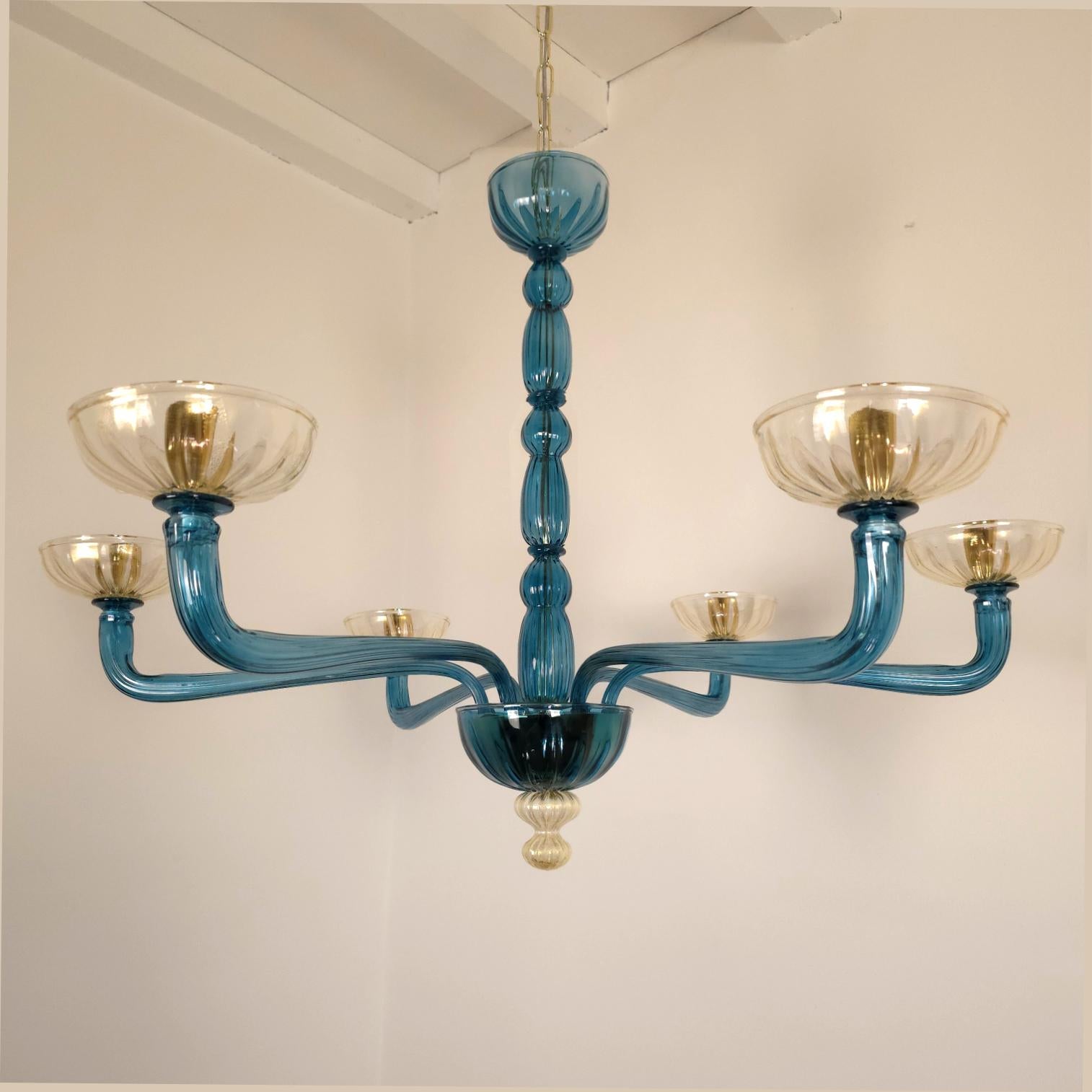 Mid-Century Modern petrol blue and clear-gold Murano glass chandelier Venini style, Italy 1980s
two chandeliers available - a pair.
Sold and priced individually.
The neoclassical style Murano glass chandelier has six light and arms.
The chandelier