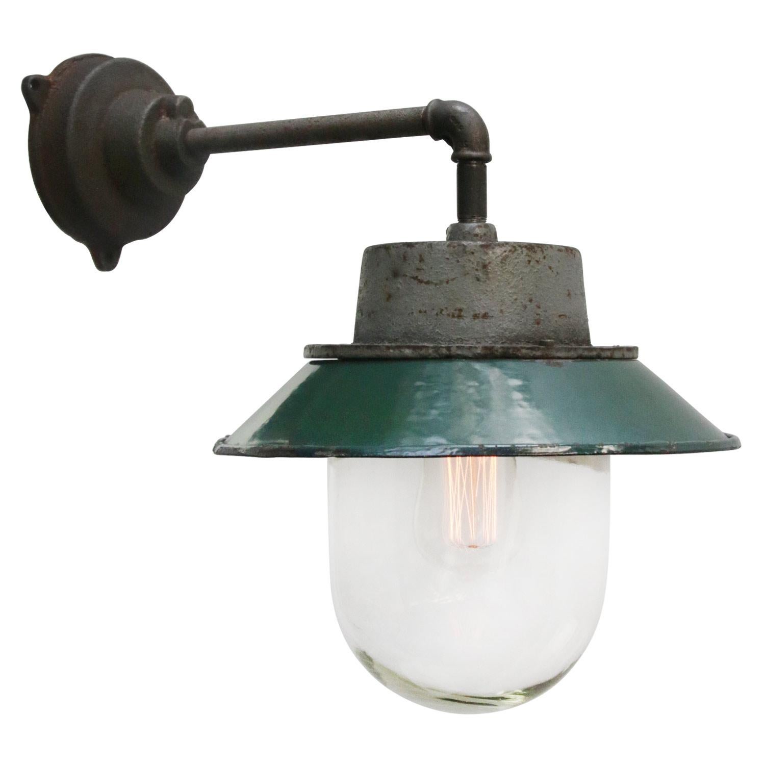 Petrol enamel industrial wall lamp with white interior.
Petrol cast iron top, cast iron arm
Clear glass 

Diameter cast iron wall piece: 12 cm. Three holes to secure.

Weight: 4.00 kg / 8.8 lb

Priced per individual item. All lamps have been