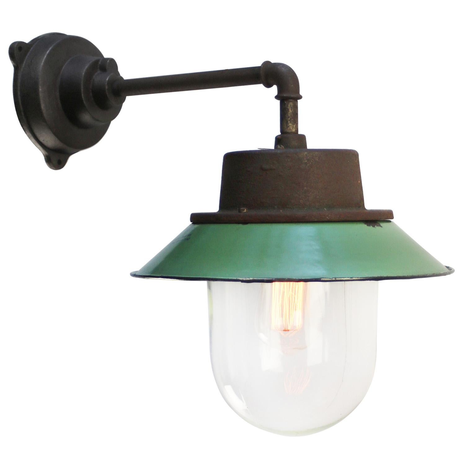 Petrol enamel industrial wall lamp with white interior.
Clear glass. 

Diameter cast iron wall piece: 12 cm. Three holes to secure.

Weight: 6.70 kg / 14.8 lb

Priced per individual item. All lamps have been made suitable by international standards