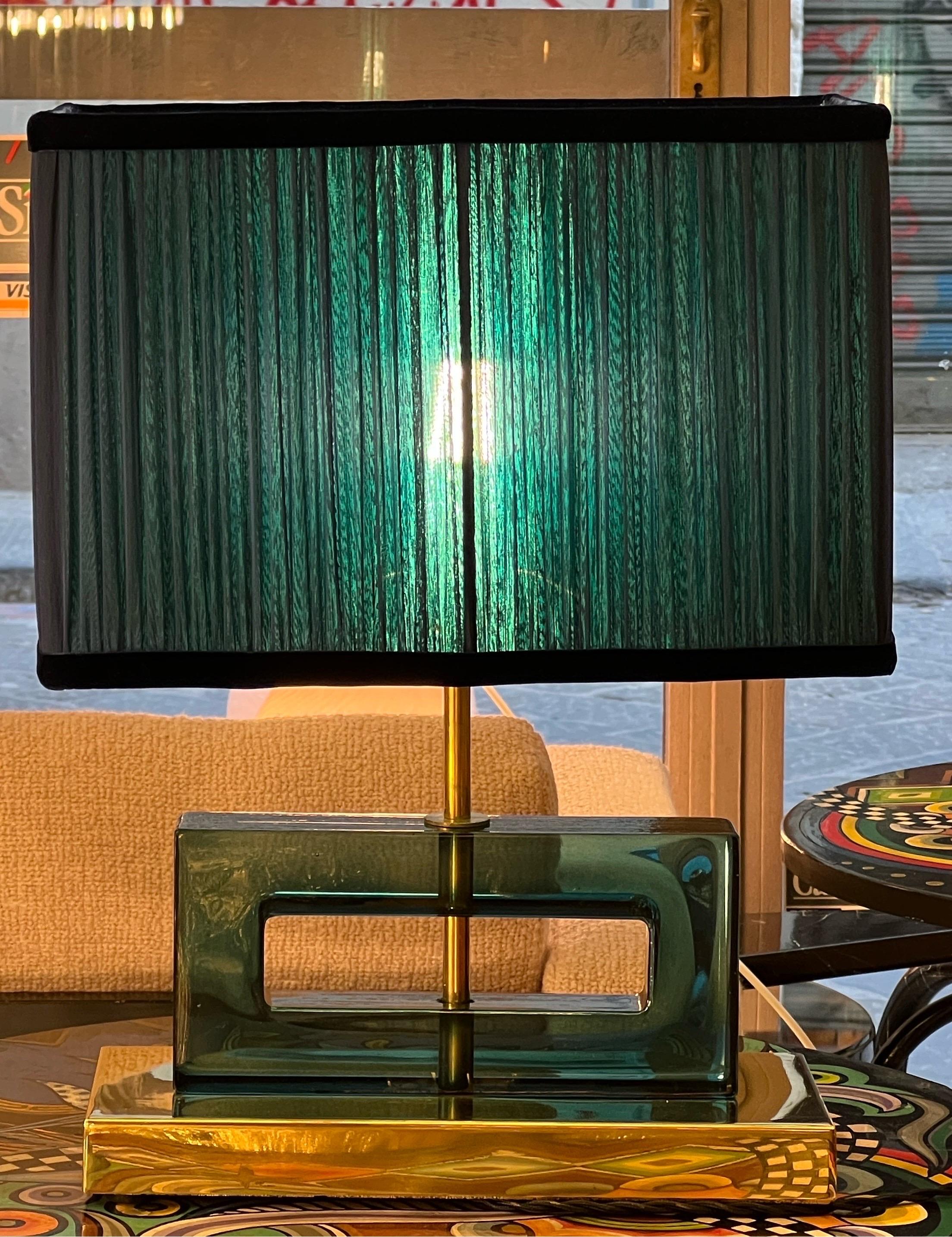 Petrol green Murano glass blocks lamps with brass base and our hand sewn blue and green lampshades.
The geometric glass blocks are solid, thick and heavy.
The double color lampshades are handmade in our internal laboratory using ruffled double color