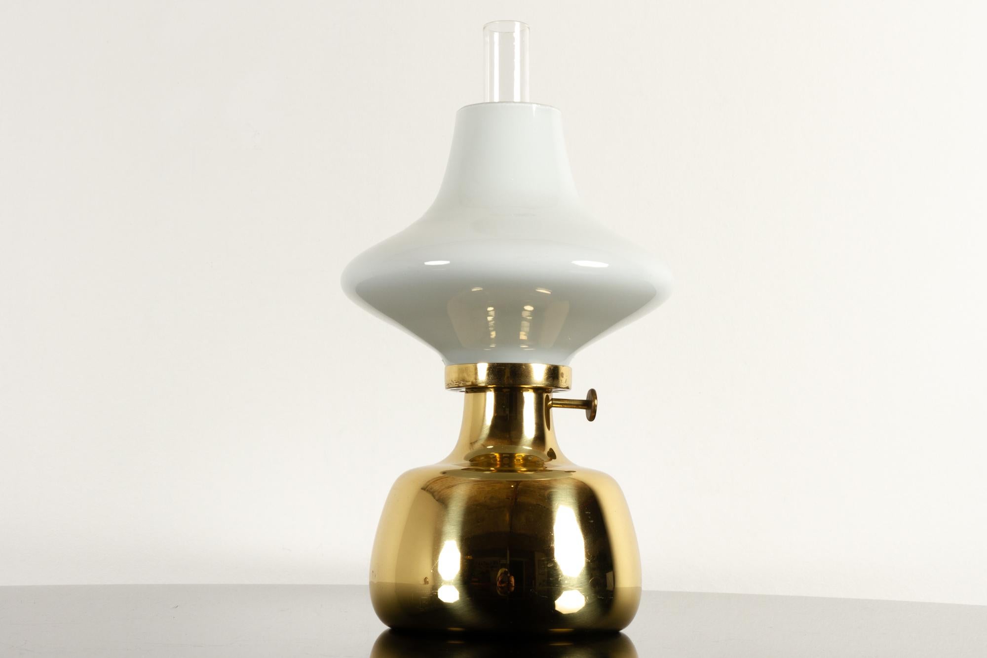 Petronella lamp by Henning Koppel for Louis Poulsen, 1960s.
Danish oil lamp in brass and white opaline glass. Designed by Danish designer Henning Koppel in 1961. The lamp body was handmade by Louis Poulsen in Denmark. The glass parts were made by