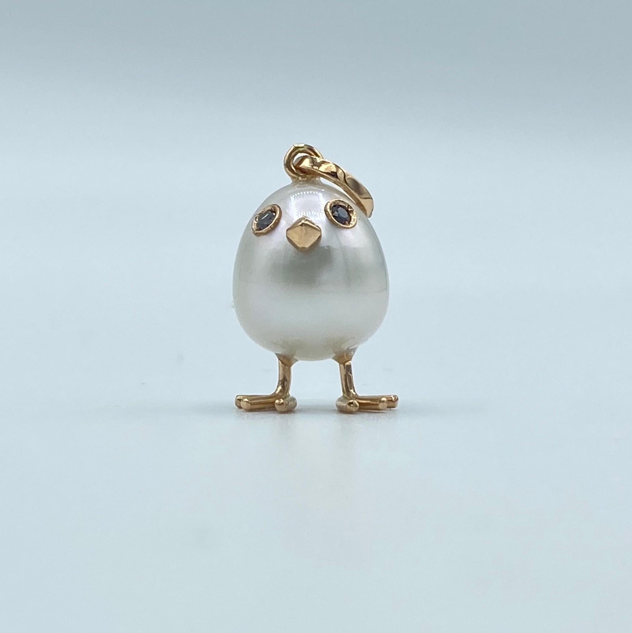 Chick Australian Pearl Diamond Yellow Red white 18 Kt Gold Pendant  Necklace
A oval shape Australian pearl has been carefully crafted to make a chick. He has his two legs, two eyes encrusted with two black diamonds and his beak. 
The gold is