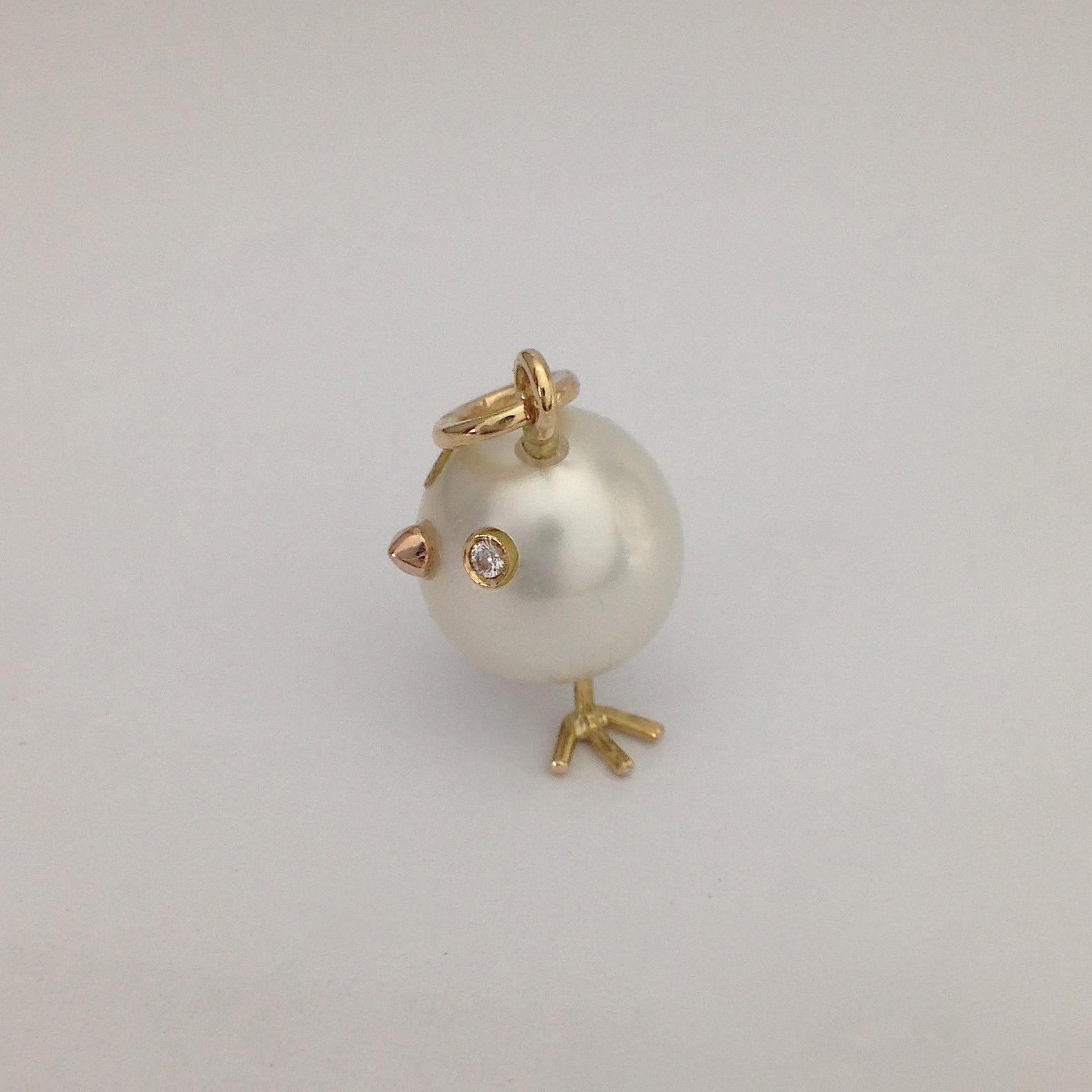An Australian pearl has been carefully crafted to make a chick. He has his two legs, two eyes encrusted with two white diamonds and his beak. 
The gold is red for the beak, for the other elements it's yellow.
The caliber is ct 0.02
The chain is not