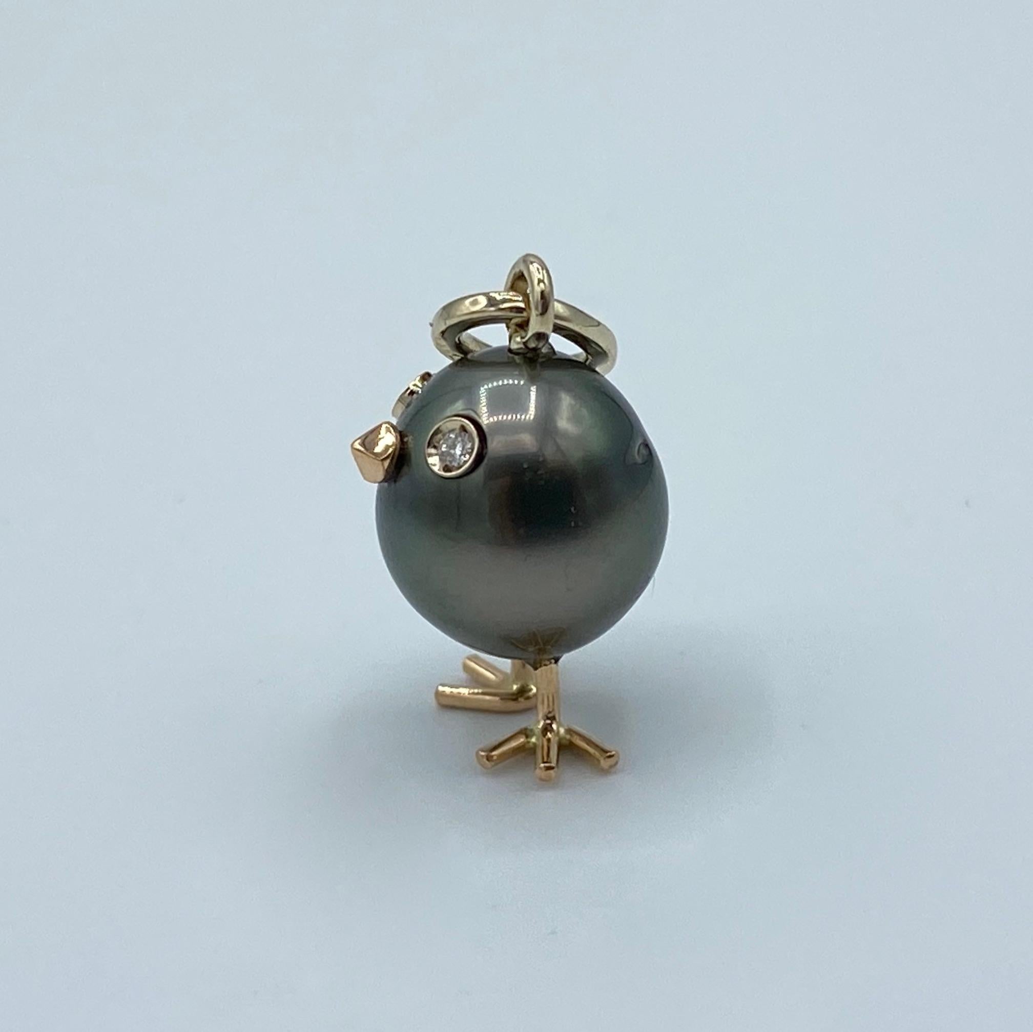 Chick South Sea Pearl White Diamond Red Gold 18Kt Pendant or Necklace
A beautiful Tahitian pearl has been carefully crafted to make a chick. He has his two legs, two eyes encrusted with two white diamonds and his beak. 
The gold is white for the
