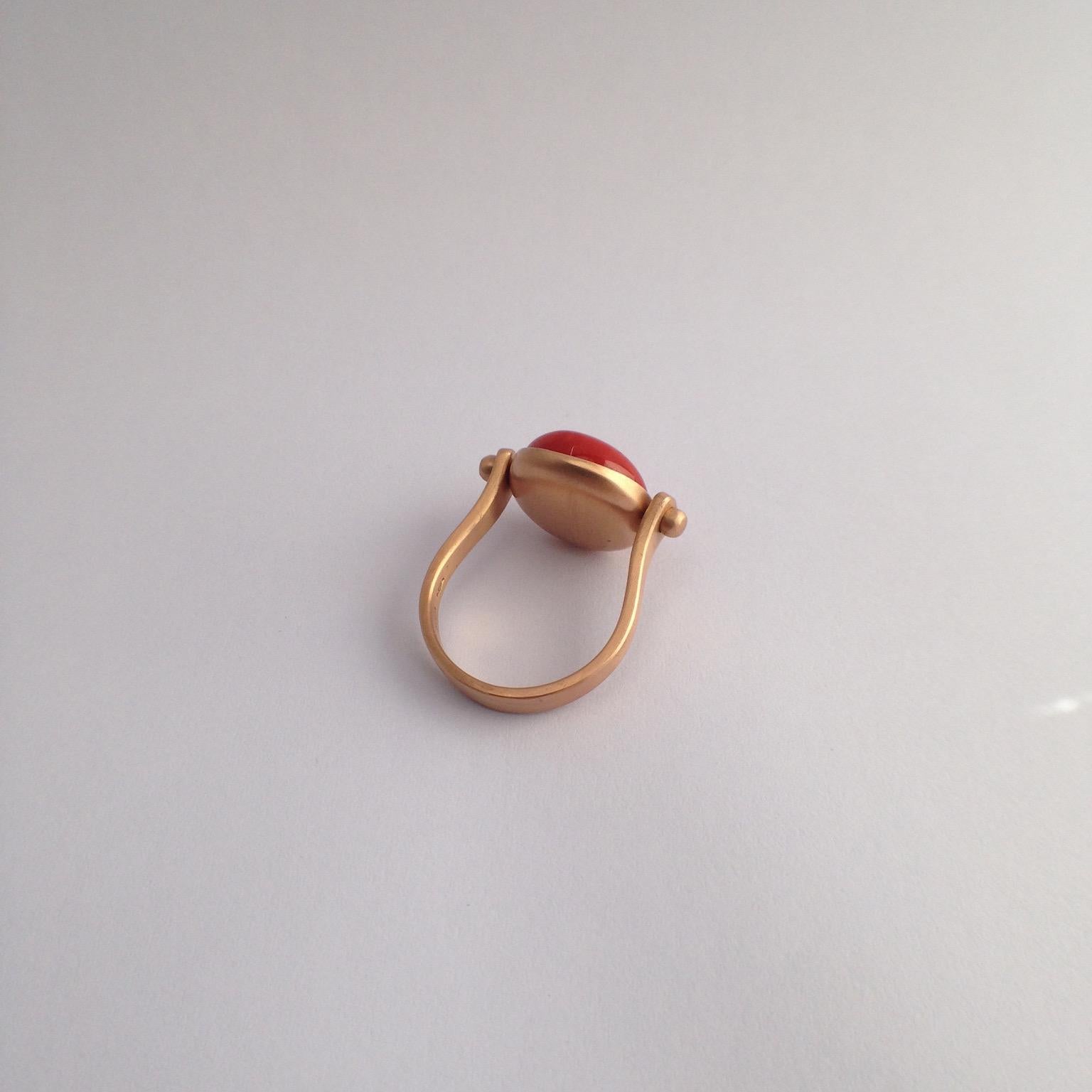 Gemstone Red Coral Roman Style Red 18 Kt Gold Reversible Italian Ring
This ring is inspired by my love of ancient Roman jewelry. They used to wear  a ring where its head would be round. 
There's a red round coral as a button above and if you round
