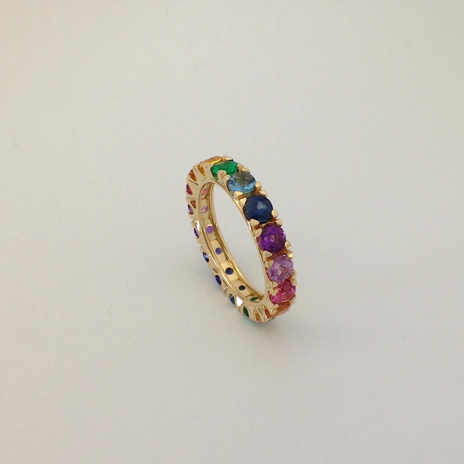 Rainbow Sapphire Emerald Semiprecious Stone 18 Karat Gold Ring Made in Italy
This multicolor eternity ring is set from 17 stones. It has yellow, orange, violet and blue sapphire; emerald, tourmaline, iolite, aquamarine e amethyst. 
I put the stones