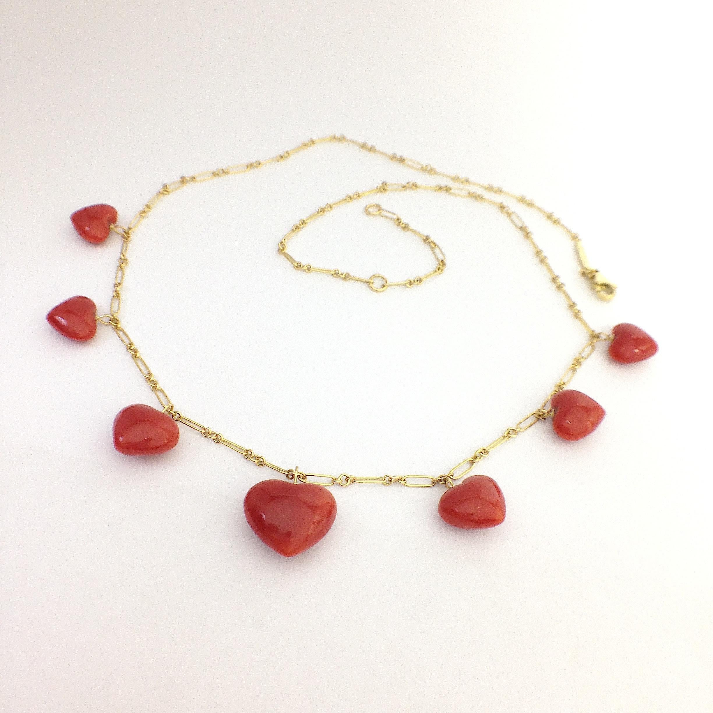 Italian Natural Red Coral Heart Necklace Handmade 18 Karat Gold made in Italy
This is a necklace completely handmade in yellow 18Kt gold.
It has 7 red coral hearts positioned from smaller to larger towards the center of the necklace.
It is 43 cm or