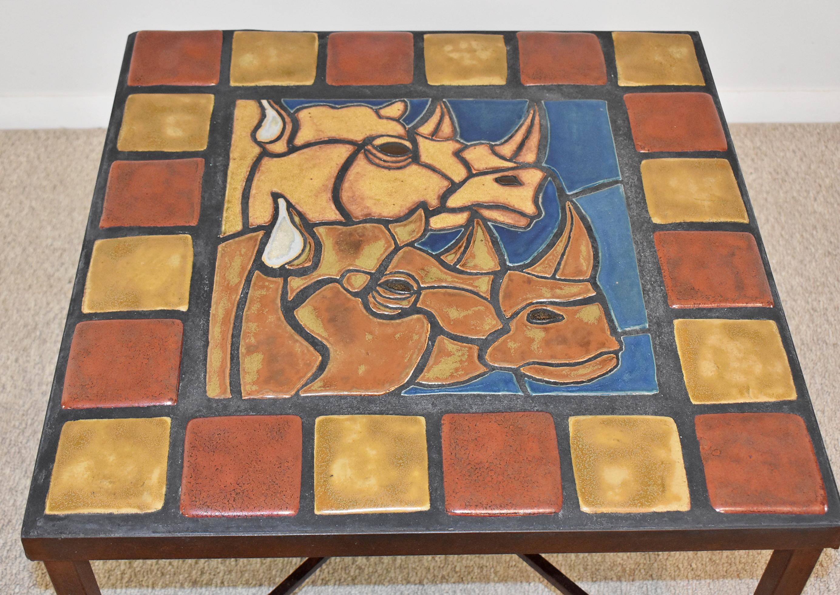 Pewabic Tile Top Table. Rhinos inlaid tile top design with wrought iron frame. Rhinoceros heads with alternating square border tiles. Authenticated by Pewabic Pottery, Detroit, MI with paperwork attached to photos. Great condition consistent with