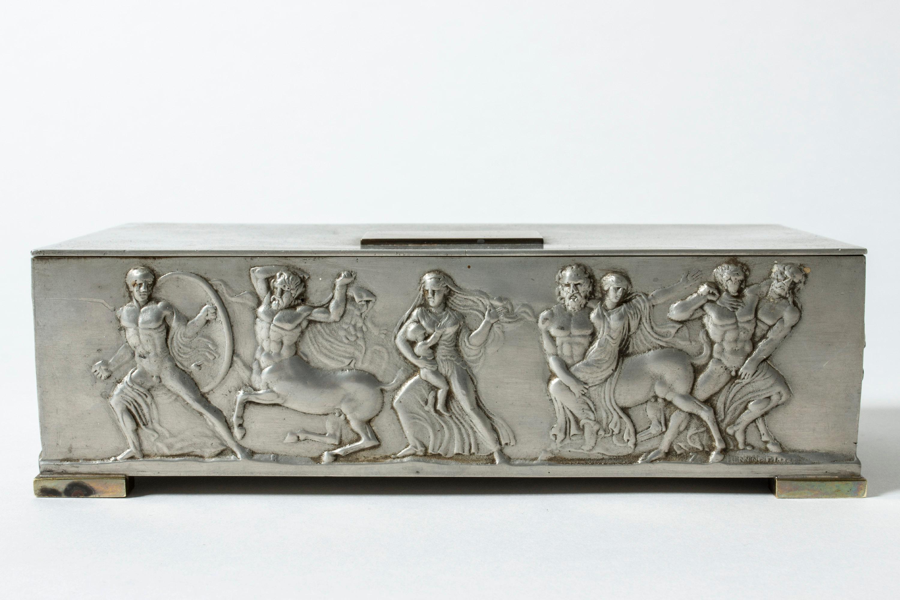 Beautiful pewter box from Herman Bergman, adorned with a strict pewter rectangle on top. Beautiful execution.

The images depicted are from the Bassai (sometimes spelled Bassae) Frieze, which was originally a part of the Temple of Apollo