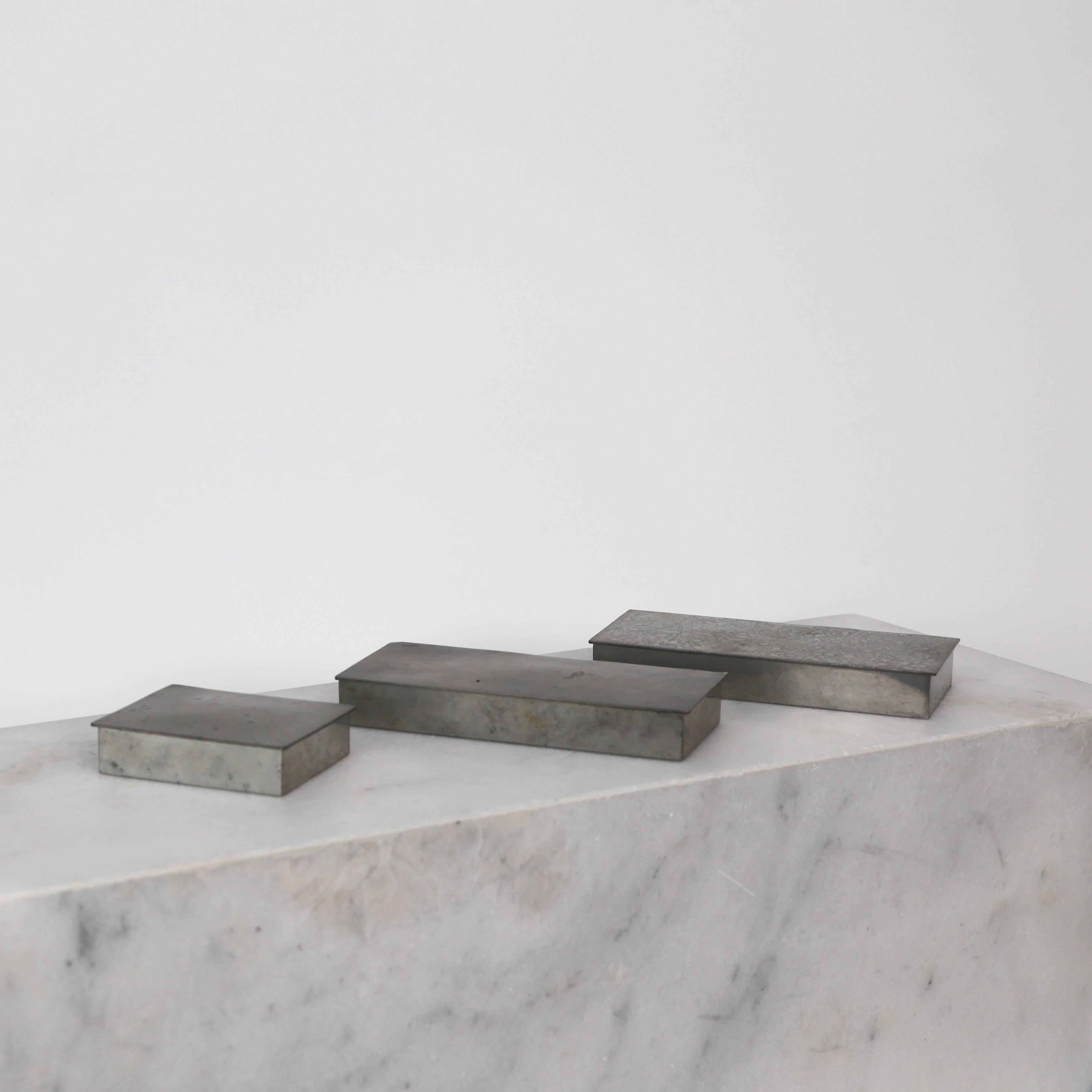 Collection of three Pewter Boxes designed by Arne Erkers for Just Andersen in the 1950s. An elegant trio for a beautiful place.

* Two (3) lidded boxes in pewter with wooden inner boxes. Originally cigarette boxes.
* Designer: Arne Erkers
* Style: