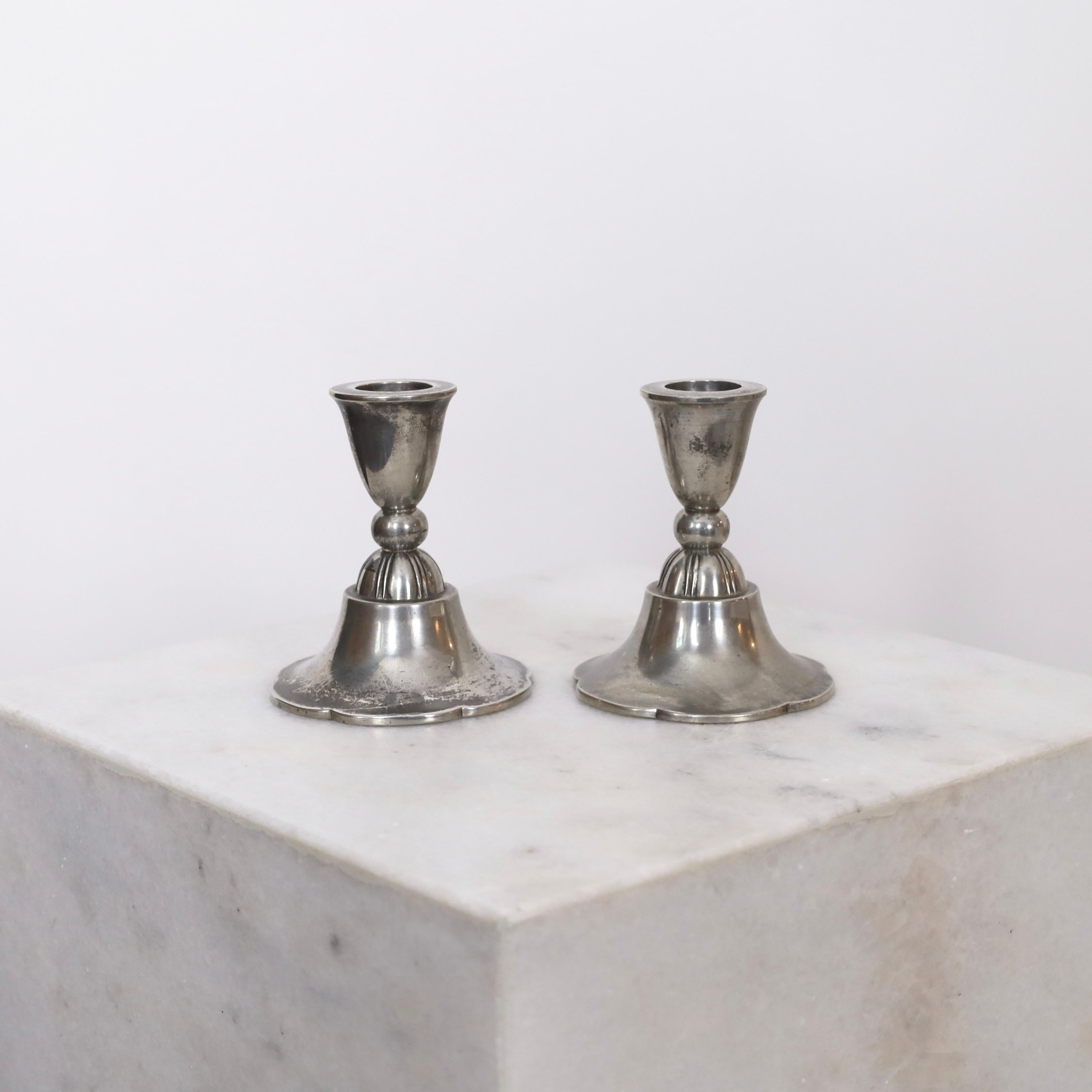 Set of Pewter Candle Holders designed by Just Andersen in 1920s. A fine set for a beautiful place. 

* Pair of small Pewter Candlestick Holders
* Designer: Just Andersen
* Manufacturer: Just Andersen
* Style: 1100
* Year: 1918-1929
* Condition: Good