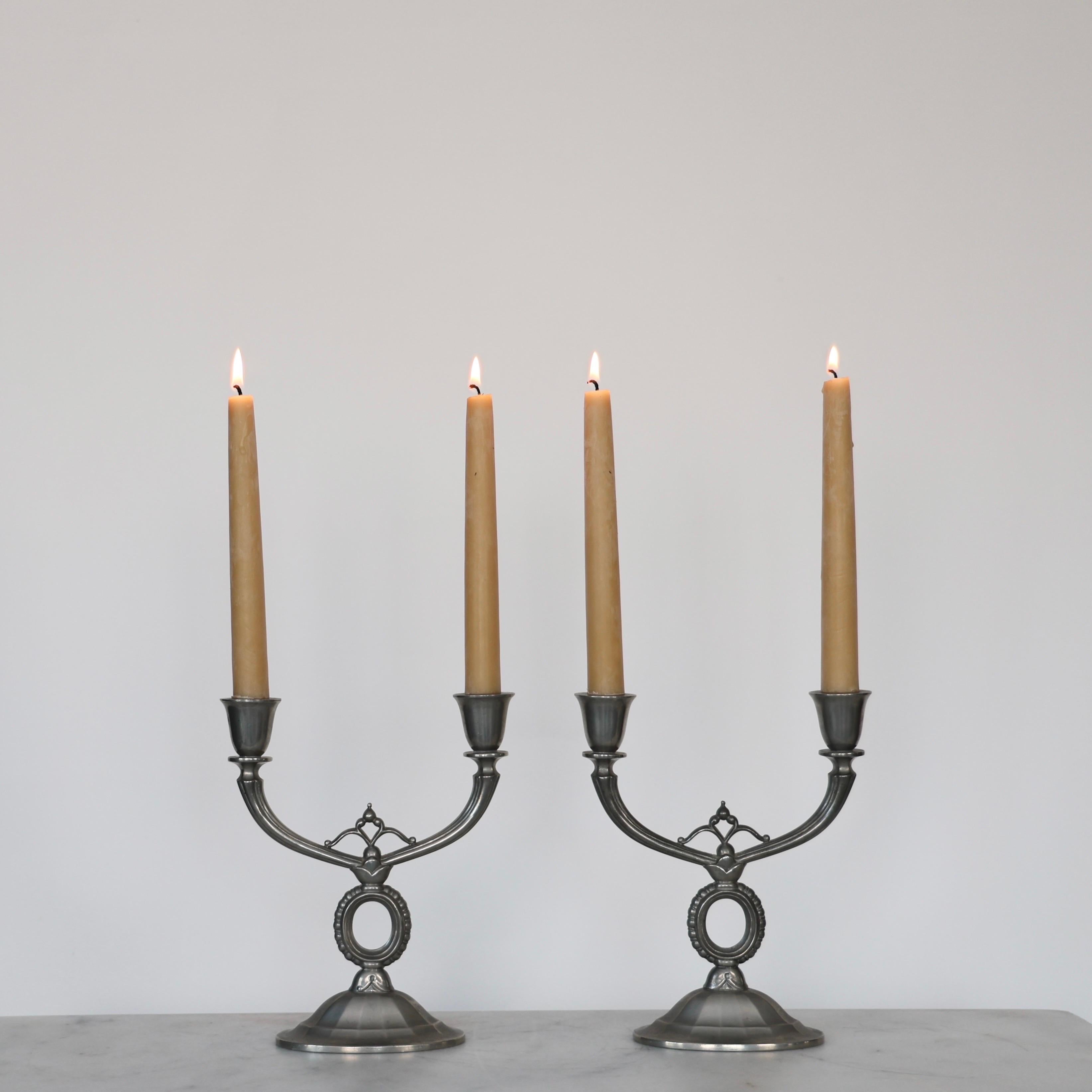 Pewter Candlestick Holders made by Just Andersen in the 1920s. An elegant set for a beautiful table. 

* Set (2) of Pewter Candlestick Holders fit for two candles 
* Manufacturer: Just Andersen
* Style: 113 and 617 
* Year: 1918-1929
* Condition: