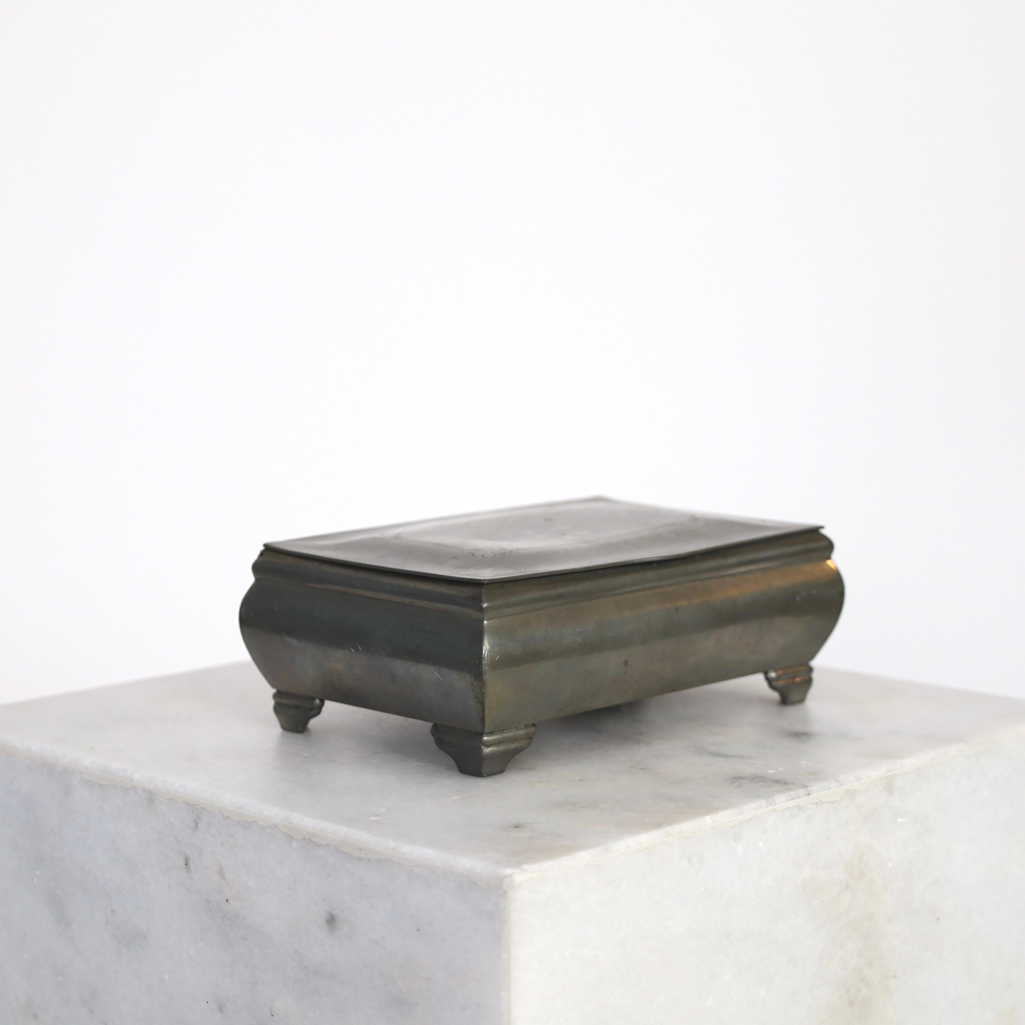 Zinnschatulle mit Deckel, entworfen von Just Andersen im Jahr 1930. Ein zeitloses Stück für einen exquisiten Ort

* Zinnschachtel mit Deckel und Innenschachtel aus Samt.
* Designer: Just Andersen
* Stil: 499
* Hersteller: Just Andersen
*