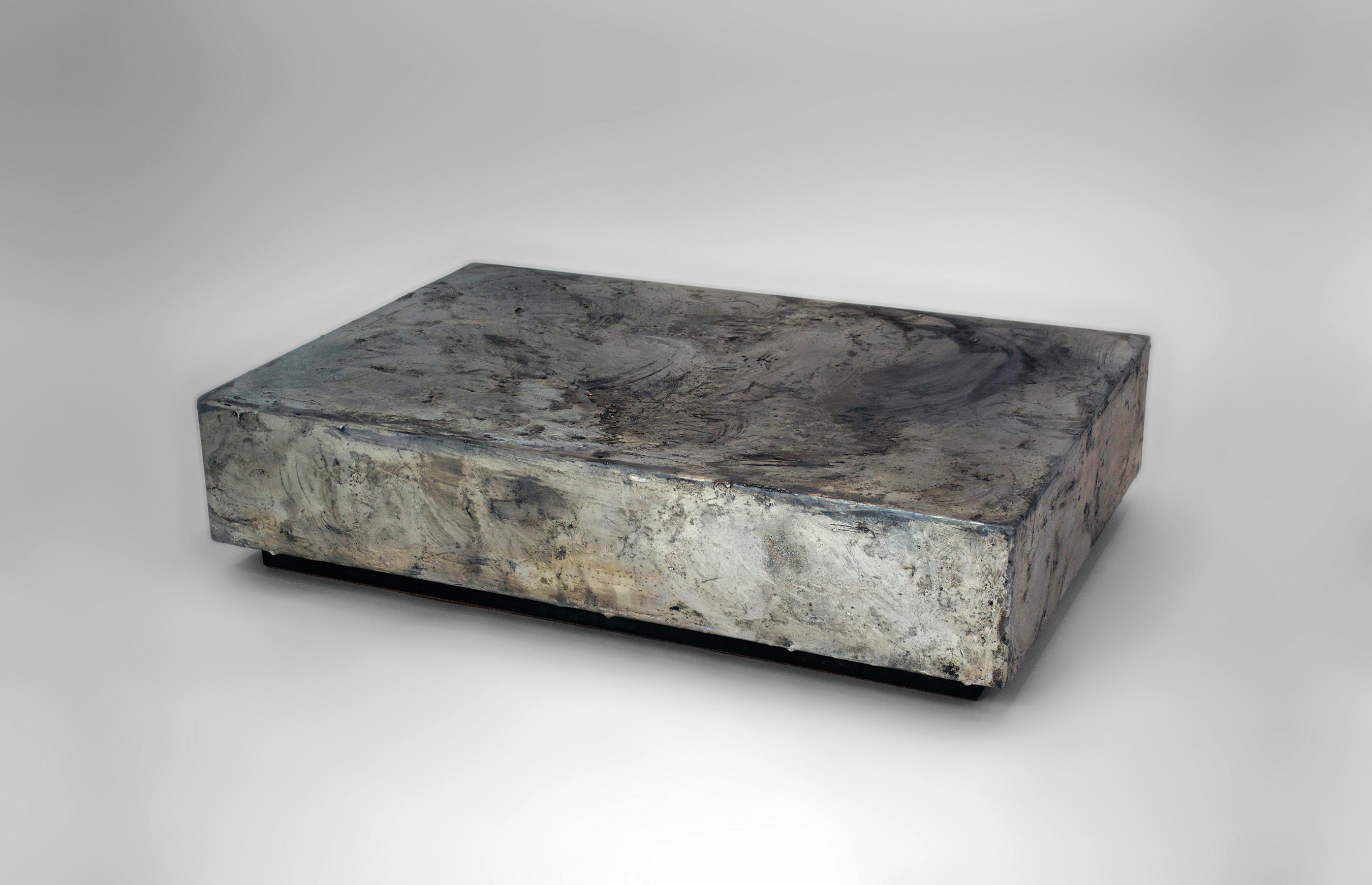 Pewter coffee table by Gentner Design
Dimensions: D 61 x W 91.5 x H 20.3 cm
Materials: pewter on steel.

The Pewter Collection is a family of furniture pieces defined by their materiality and formal qualities. One crucible at a time, pewter is