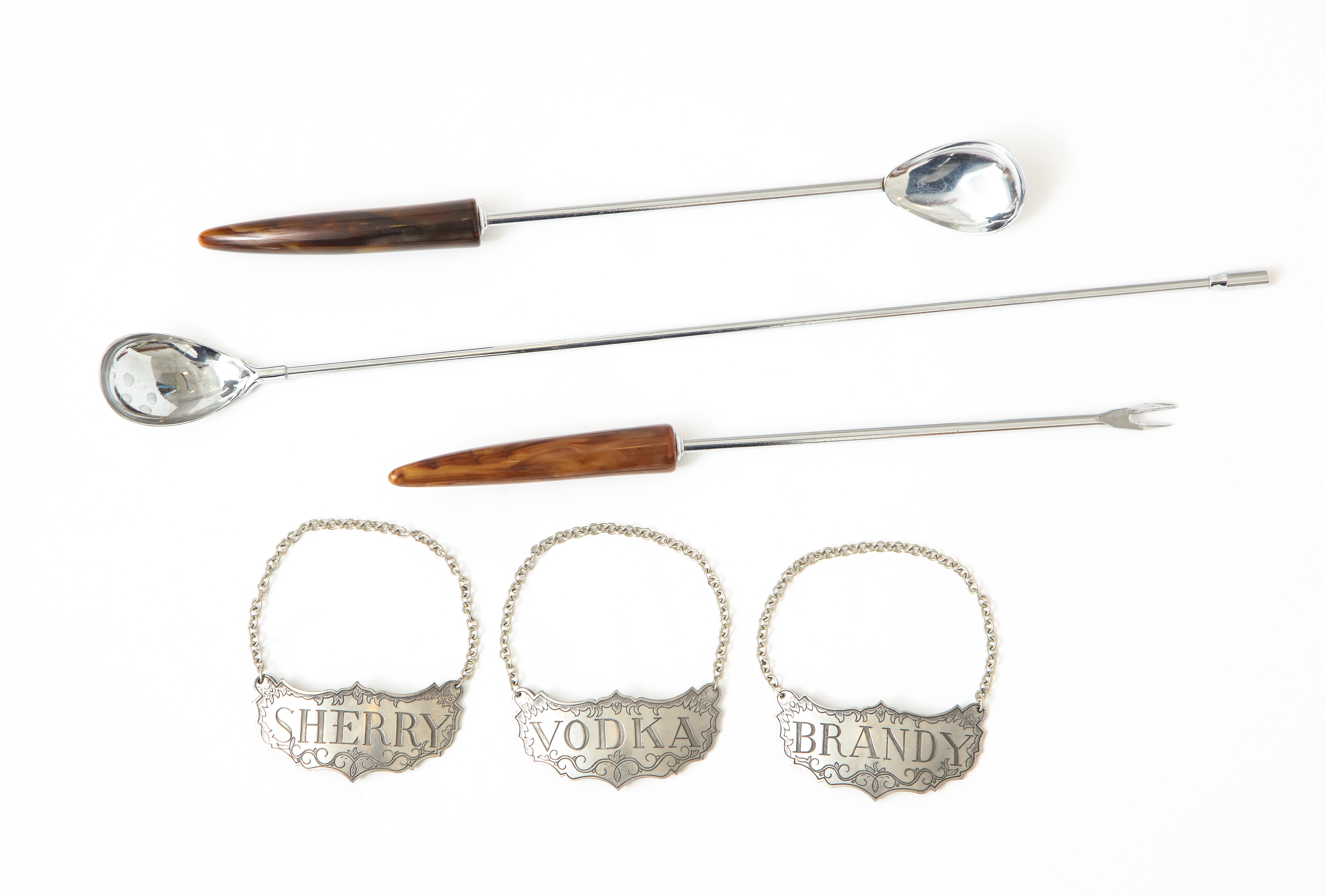 Set of 3 engraved Pewter decanter labels, Sherry, Brandy, Vodka along with 2 Martini stirrers and garniture fork with simulated horn.

Long Stirrer 15