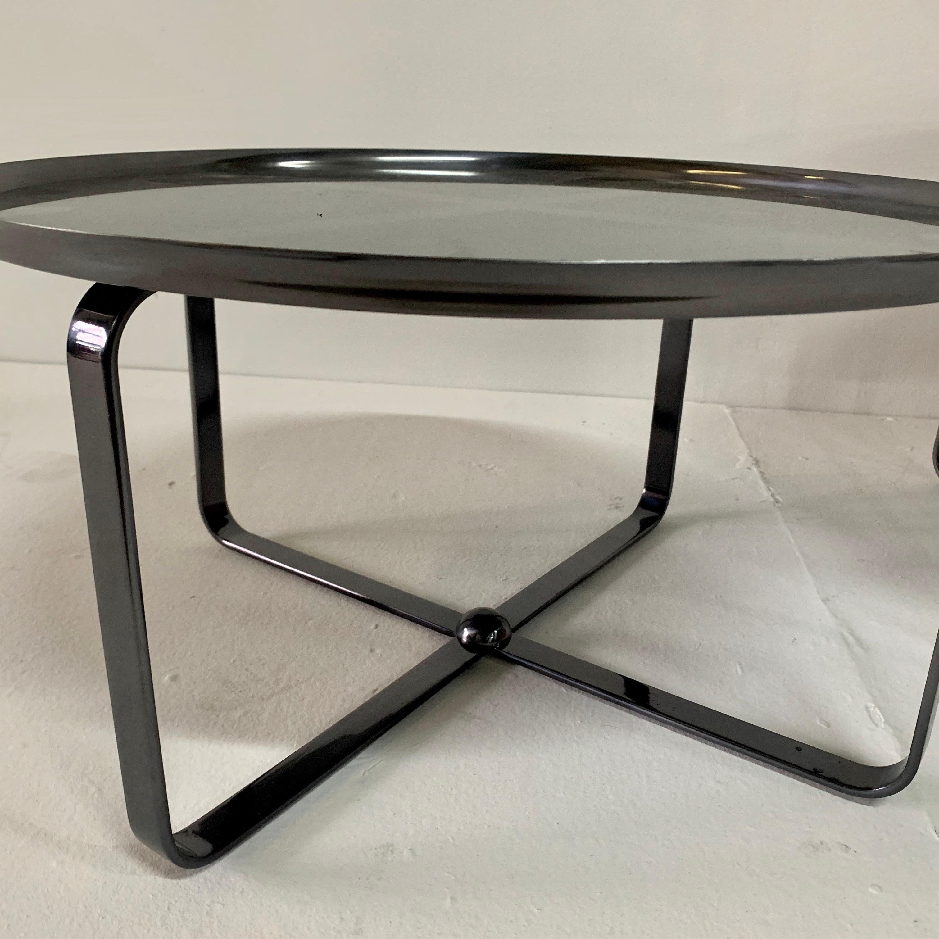 Contemporary, multi-purpose low side tables in gray pewter finish with a mirror top.

Note: dimensions of taller table is 22.75 inches diameter and 16 inches tall, lower table is 22.75 inch diameter and 12 inches tall.
