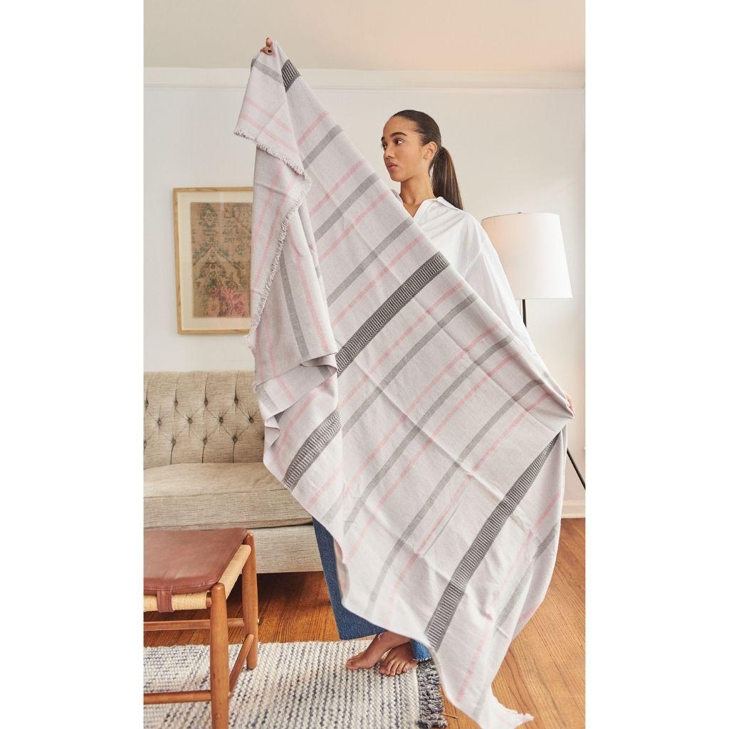 Custom design by Studio Variously, Pewter is a organic cotton throw / blanket handwoven by master weavers in Nepal. 

A sustainable design brand based out of Michigan, Studio Variously exclusively collaborates with artisan communities to restore and