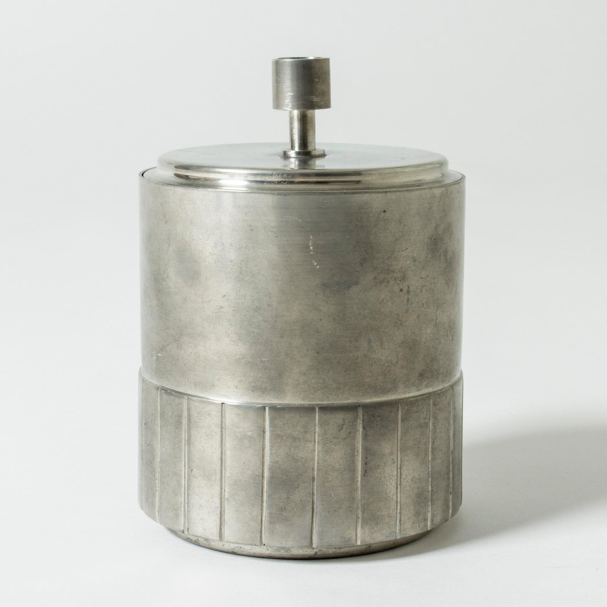 Elegant pewter jar from GAB, in a strict cylinder form with a pattern of stripes. Nice even patina.