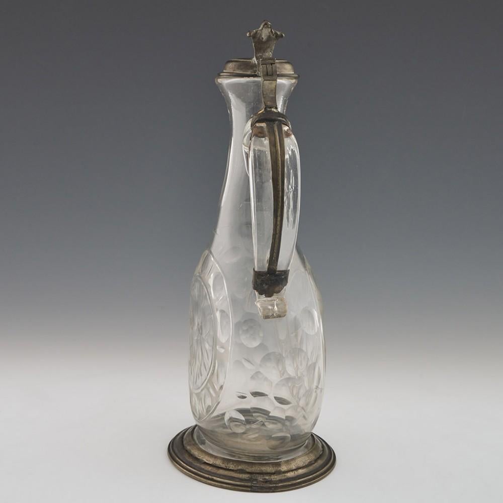 Pewter Mounted Glass Claret Jug, circa 1790

Additional Information: 
Date: c1790
Origin: Probably Bohemia or Germany
Colour: Clear
Stopper: Pewter lid
Neck: Slice cut neck with sparrow beak lip - applied top down handle with scroll finish -