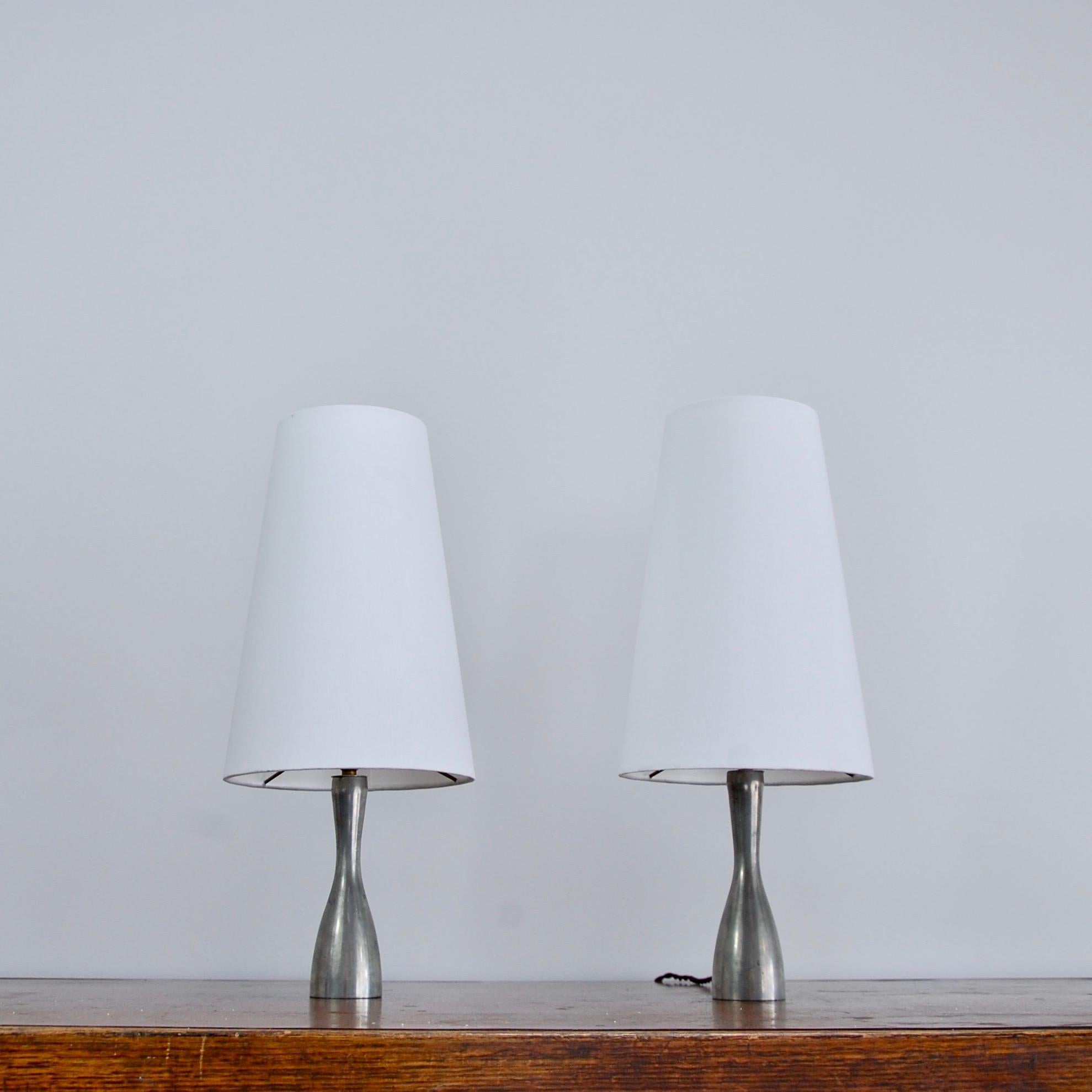 Pair of elegant Dutch pewter table lamps by Metawa of Holland from the 1960s. In pewter and fabric off-white silk shade. Rewired with single E12 candelabra based socket per table lamp. Currently wired for use in the US. Light bulbs included in