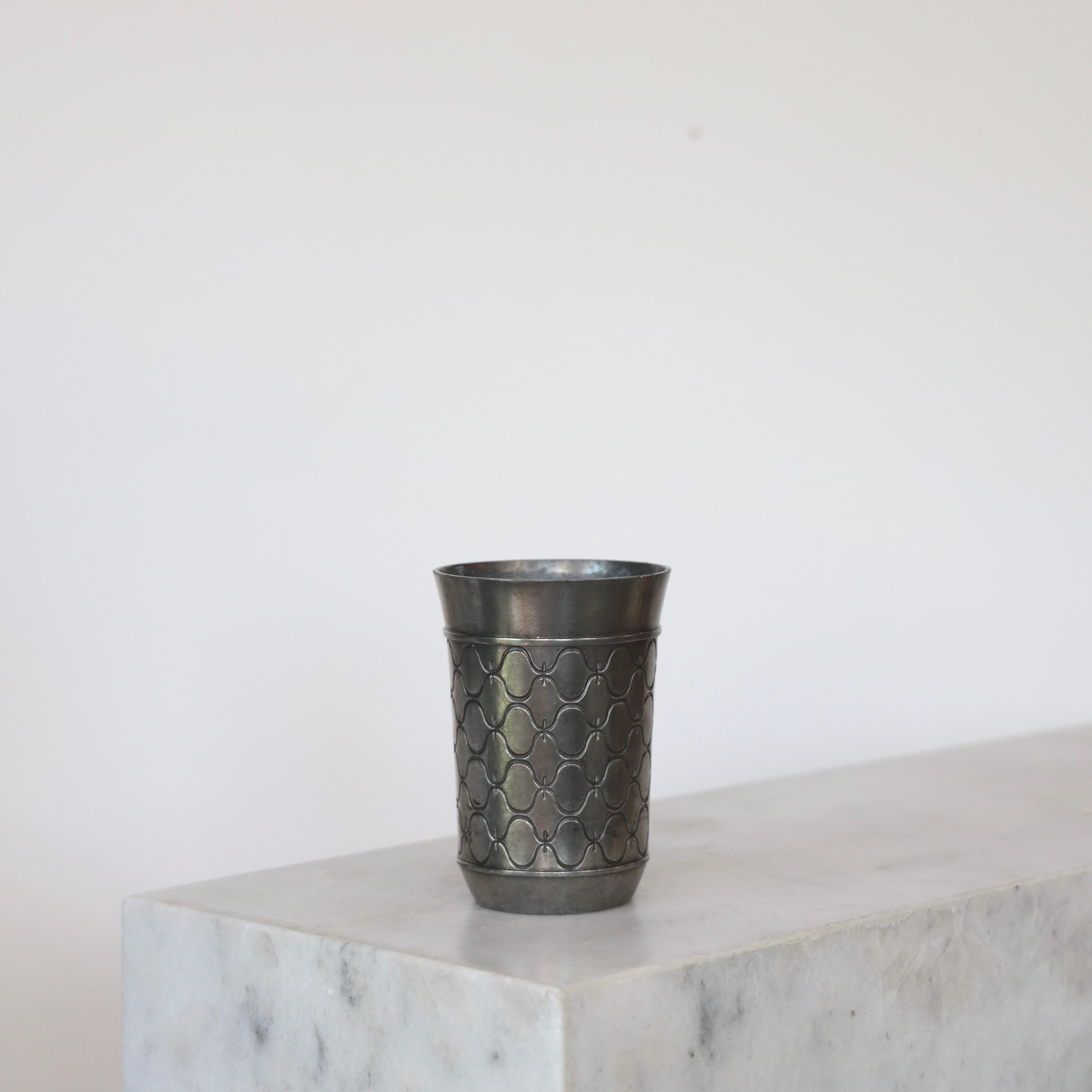 Pewter Vase made by Just Andersen in the 1950s. A fine piece for a beautiful place.

* Round pewter vase with ornaments
* Manufacturer: Just Andersen
* Style: 2753
* Year: 1956
* Condition: Good condition. Small marks and surface scratches.
