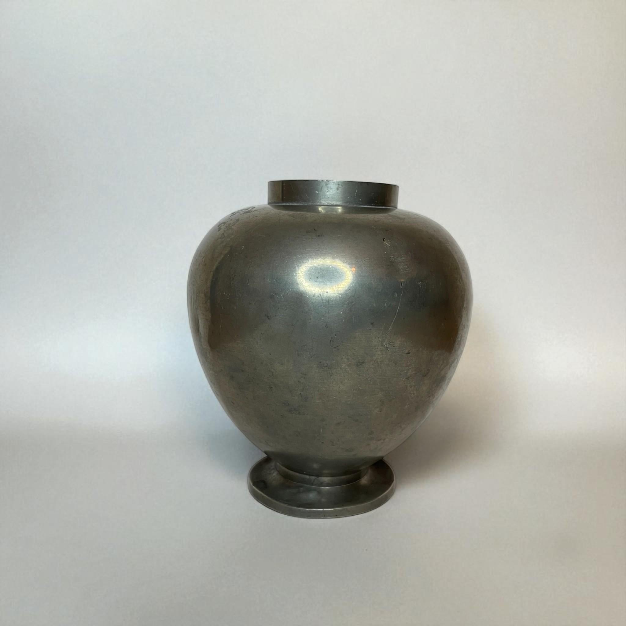 Elegant pewter vase designed by Nils Fougstedt and produced by FAK (Fabriks Aktiebolaget Silver) in 1933. The vase features a harmonious, rounded form with a refined foot and narrow neck — a fine example of Swedish functionalist metalwork from the