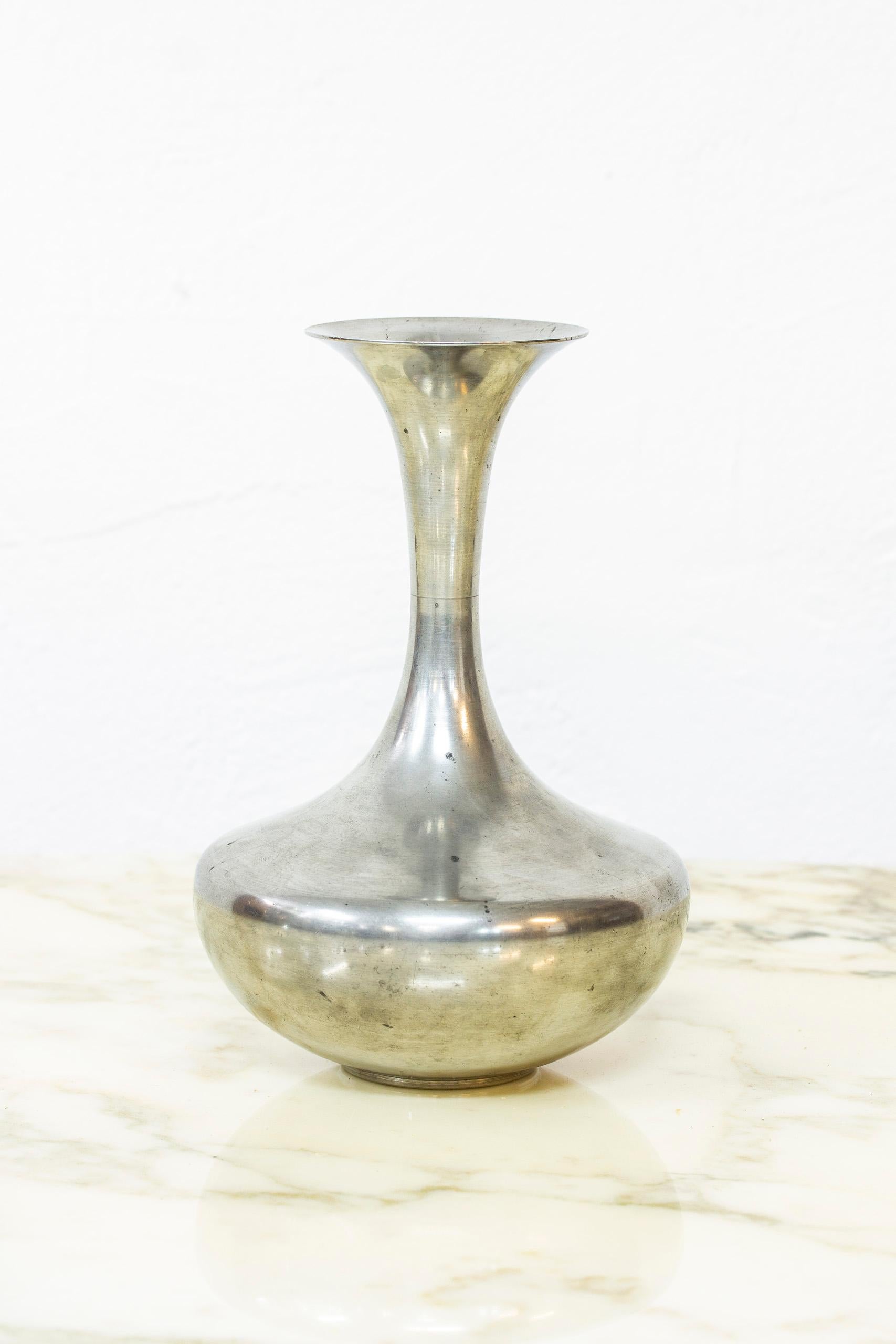 Vase produced in Stockholm by C. G. Hallberg. Most likely designed by Sylvia Stave, art director for C. G Hallberg during this time (1931-39). Made from pewter. Good condition with patina and wear according to age.

  