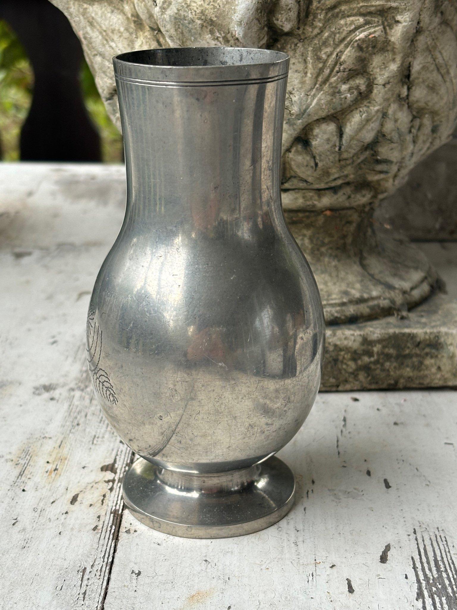 A Swedish pewter vase designed by Rolf Engströmer and produced by Fabrikaktiebolaget Kronsilver (FAK) in 1933. The vase features an elegant, rounded baluster form on a flared foot, with a finely engraved stylized floral motif. The piece embodies