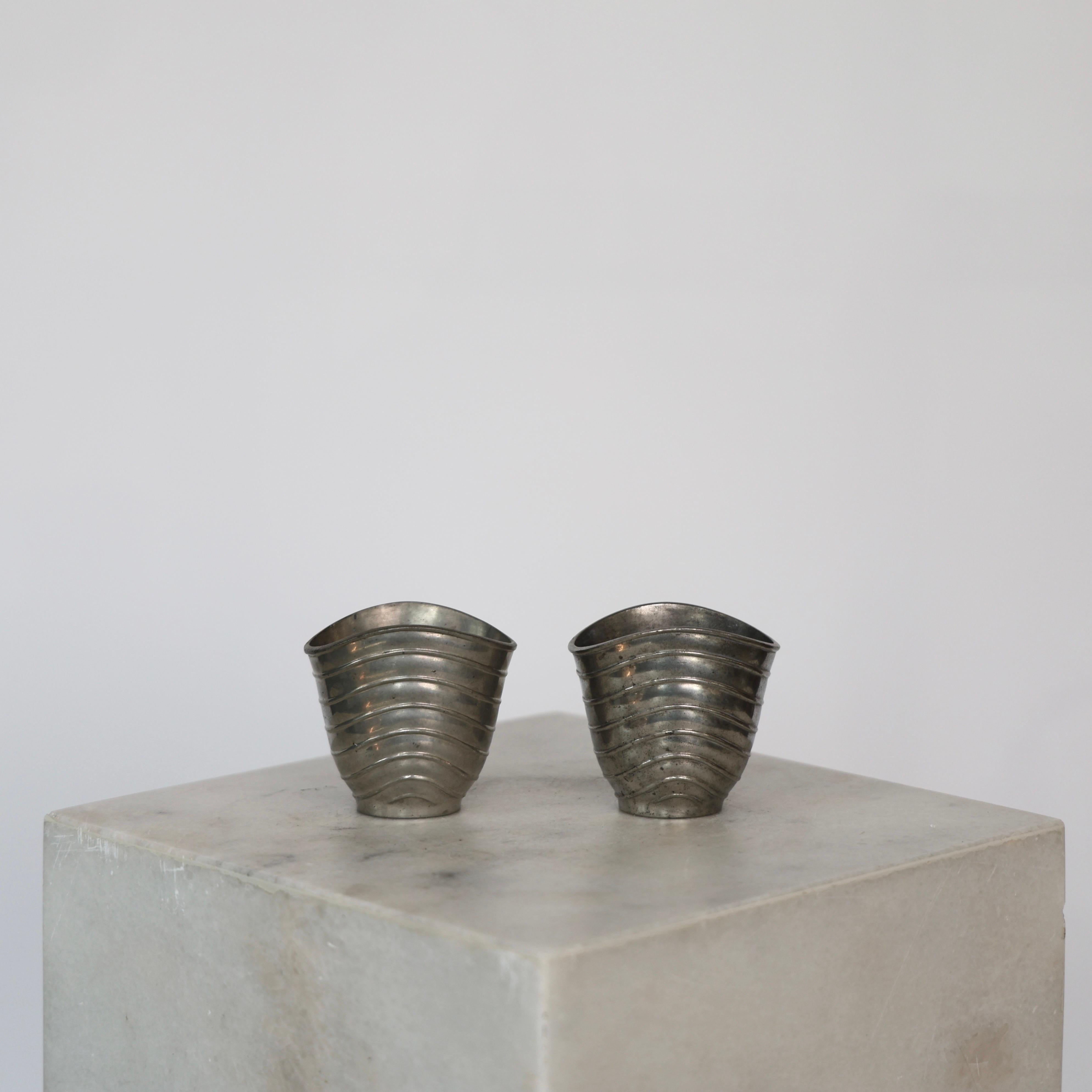 Two Elegant Pewter Vases designed by Ellen Schlanbush for Just Andersen in the early 1950s.

* Set (2) of cannelated pewter vases 
* Designer: Ellen Schlanbusch
* Manufacturer: Just Andersen
* Style: 2503 (stamped ‘Just 2503’)
* Year: 1951
*