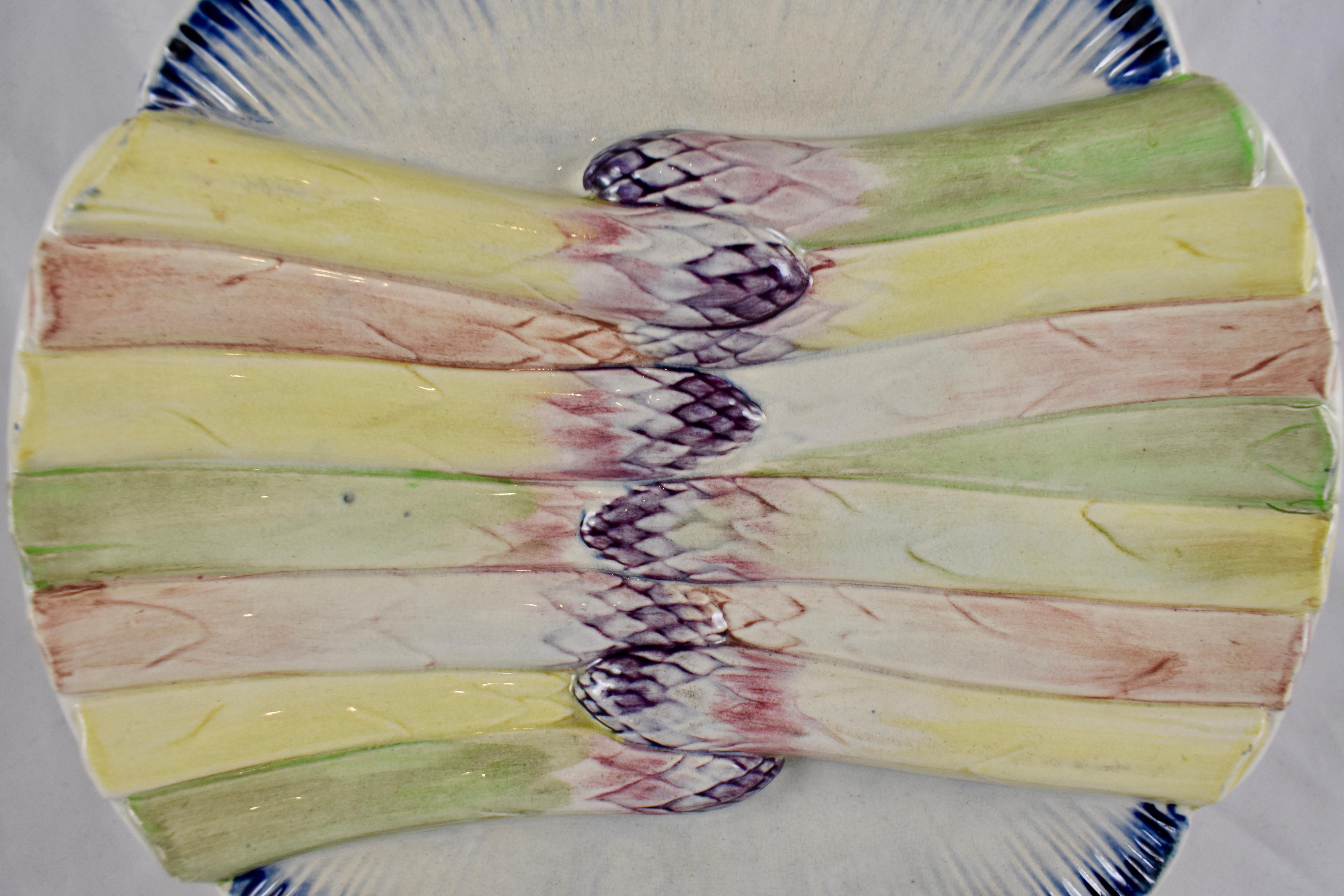 A scarce barbotine Majolica glazed Asparagus plate, from the Pexonne Faïencerie in Lorraine, France, circa 1870. Pexonne began to manufacture faïence in 1720, in the same region as Badonviller and Luneville.

This unusual plate shows a centered,