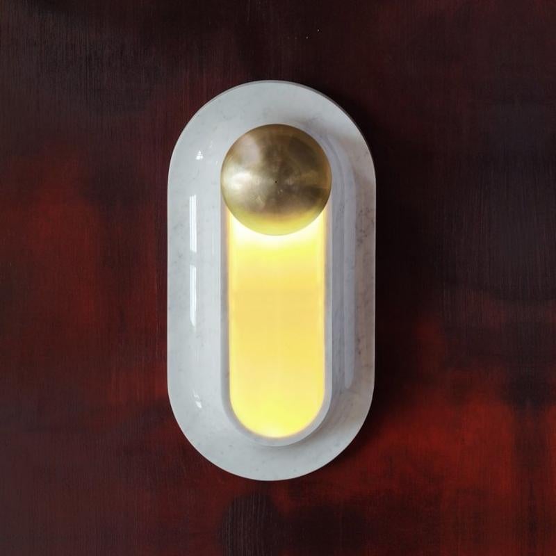 The Pfaffikon lamp is a carrara marble sconce with a hand tooled brass decorative element. The lamps provides delicate light which emerges from the frosted glass overlay.

Each sconce has the certificate of the originality and is signed. Hand