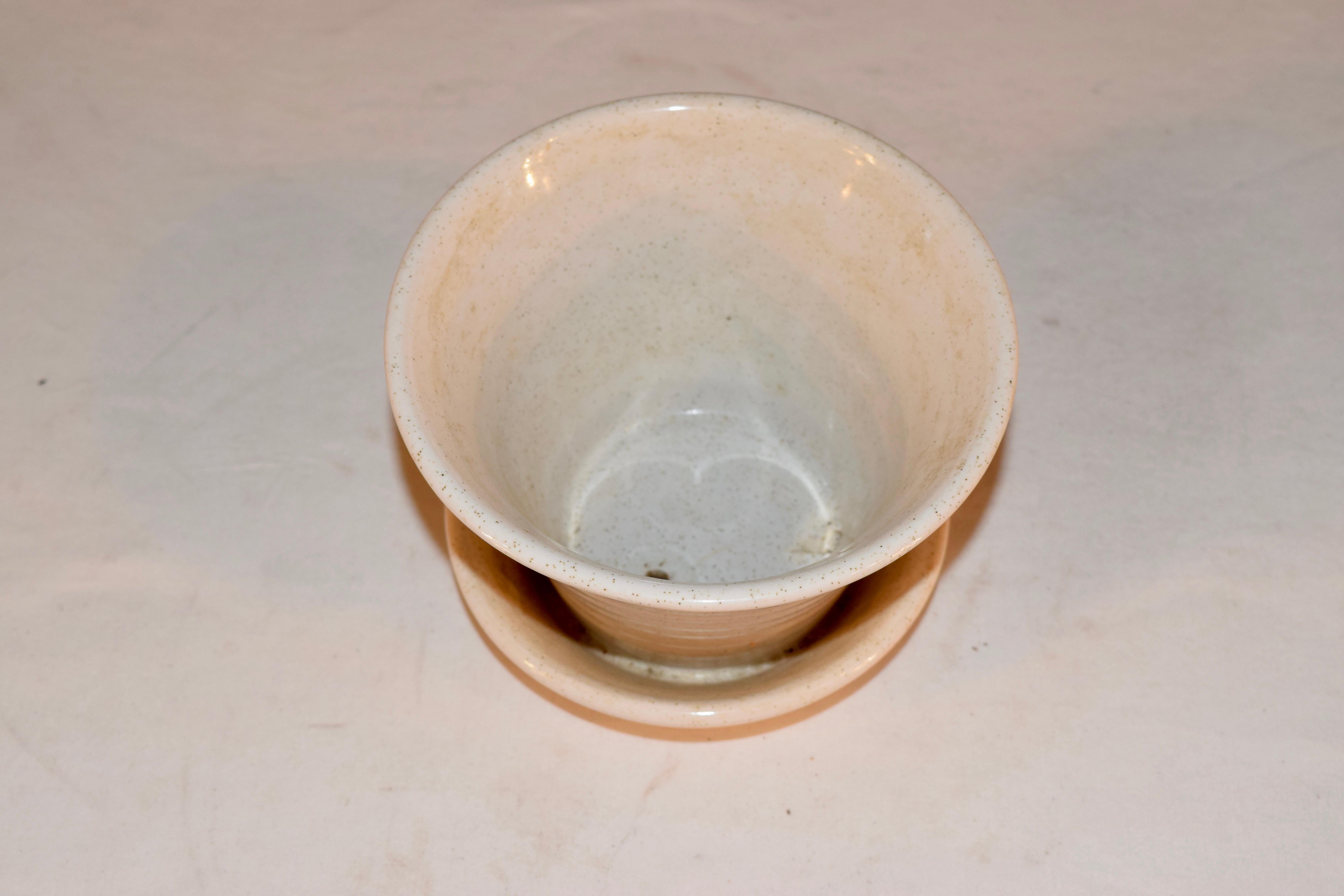 Pfaltzgraff white pottery flower pot with attached saucer, which has a water drain built in.
