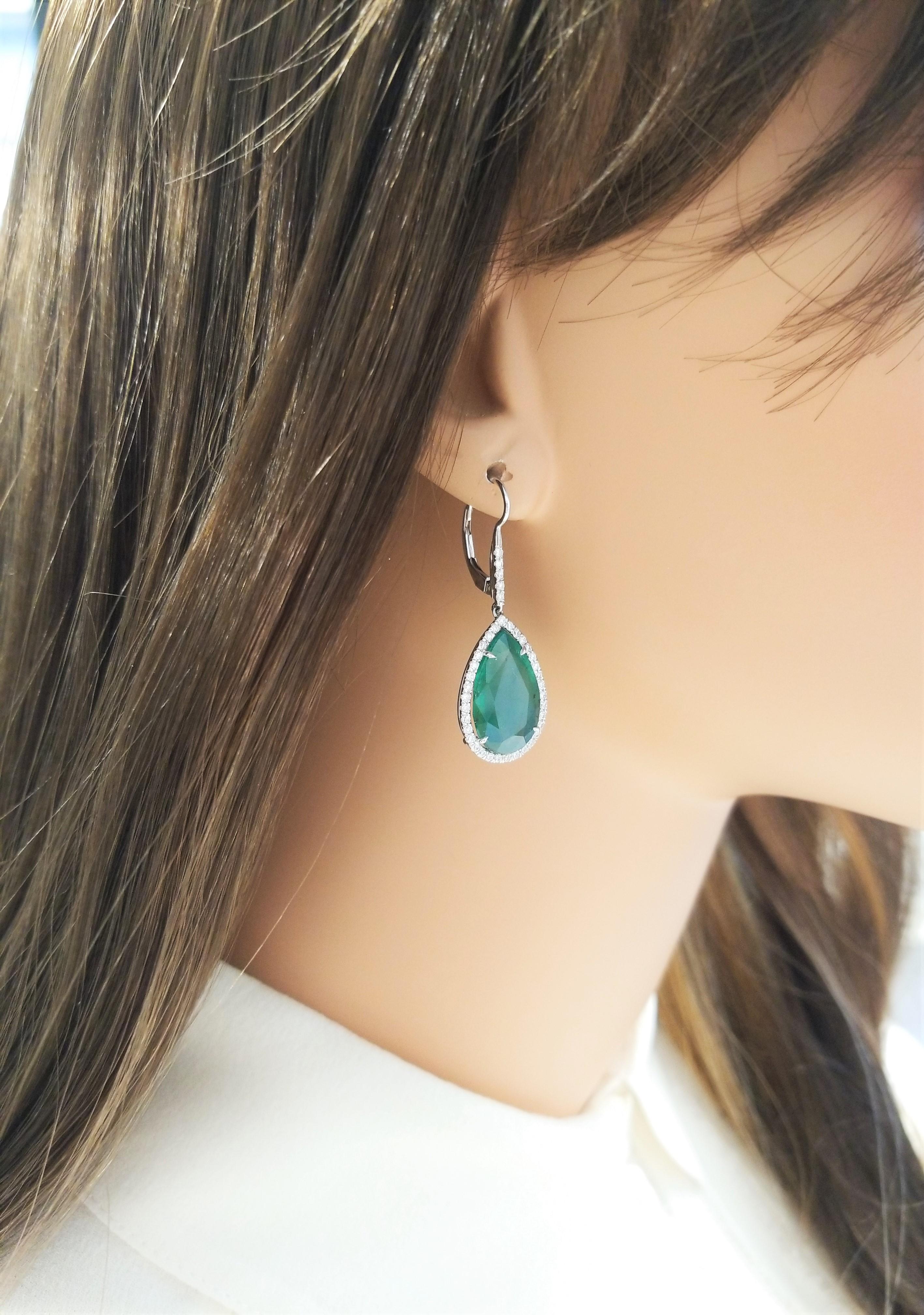 These forest-green emerald and diamond drop earrings will certainly get notice. The stunning emeralds are from Zambia. The pear shaped emeralds weigh 15.93 carat total weight and are PGS certified. Encased in a brilliant halo of 0.94 carats of