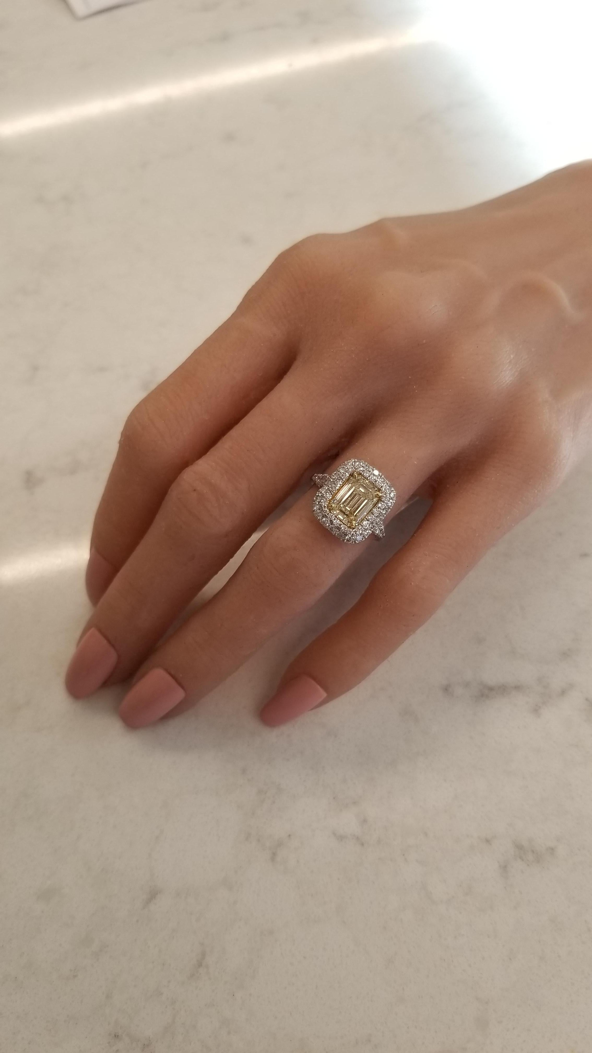This is a PGS certified emerald cut diamond that is naturally fancy intense yellow. A weight of 2.08 carats and measurements of 8.28-6.65mm in a rich yellow gold accented prong setting, the shape is layed out perfectly. It is very rare to have an