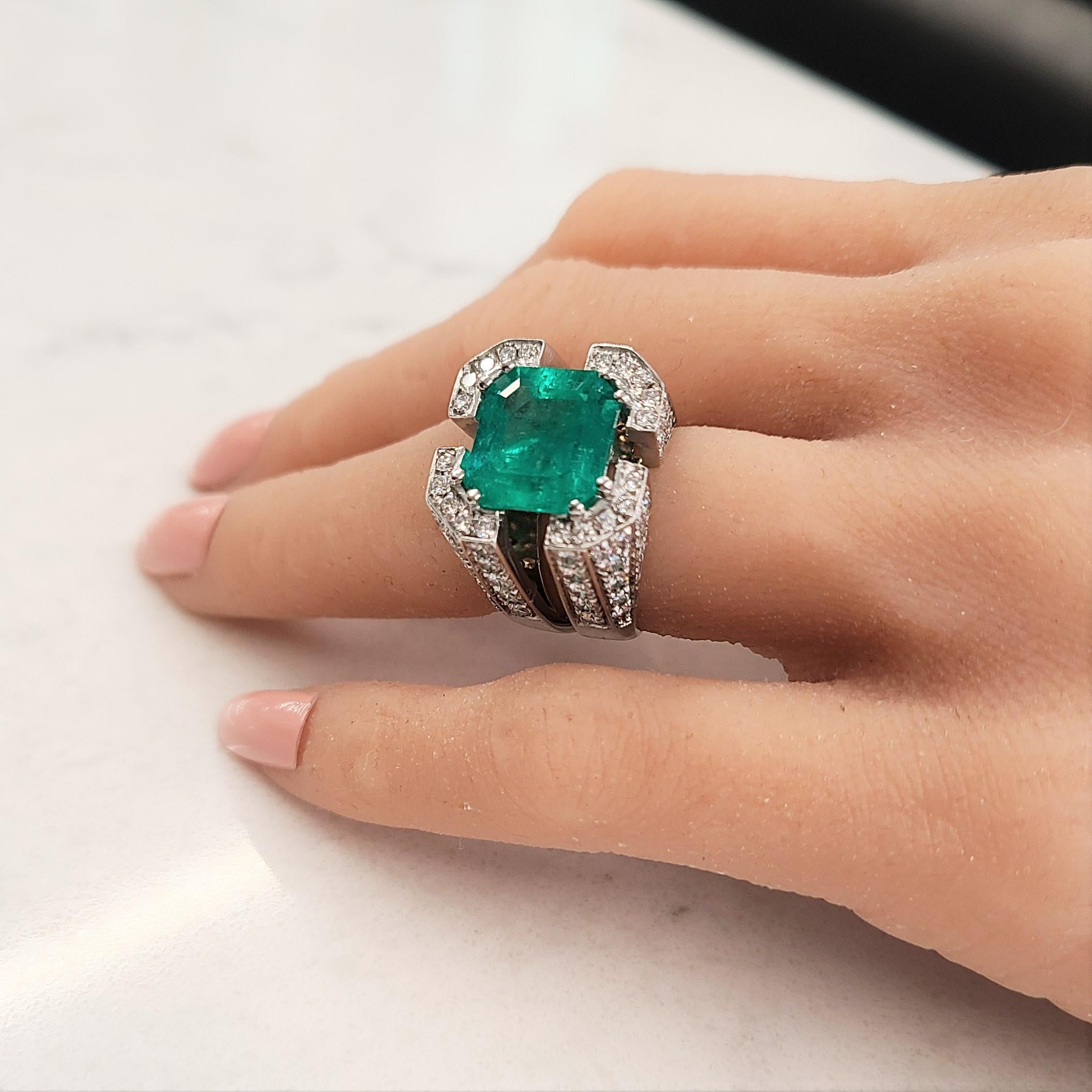 Make an entrance with this brightly polished 18k white gold cocktail anniversary ring. This stunning ring features a square cut PGS CERTIFIED fine quality Columbian emerald that exhibits a lush green grass shade and weighs 7.18 carats. This emerald