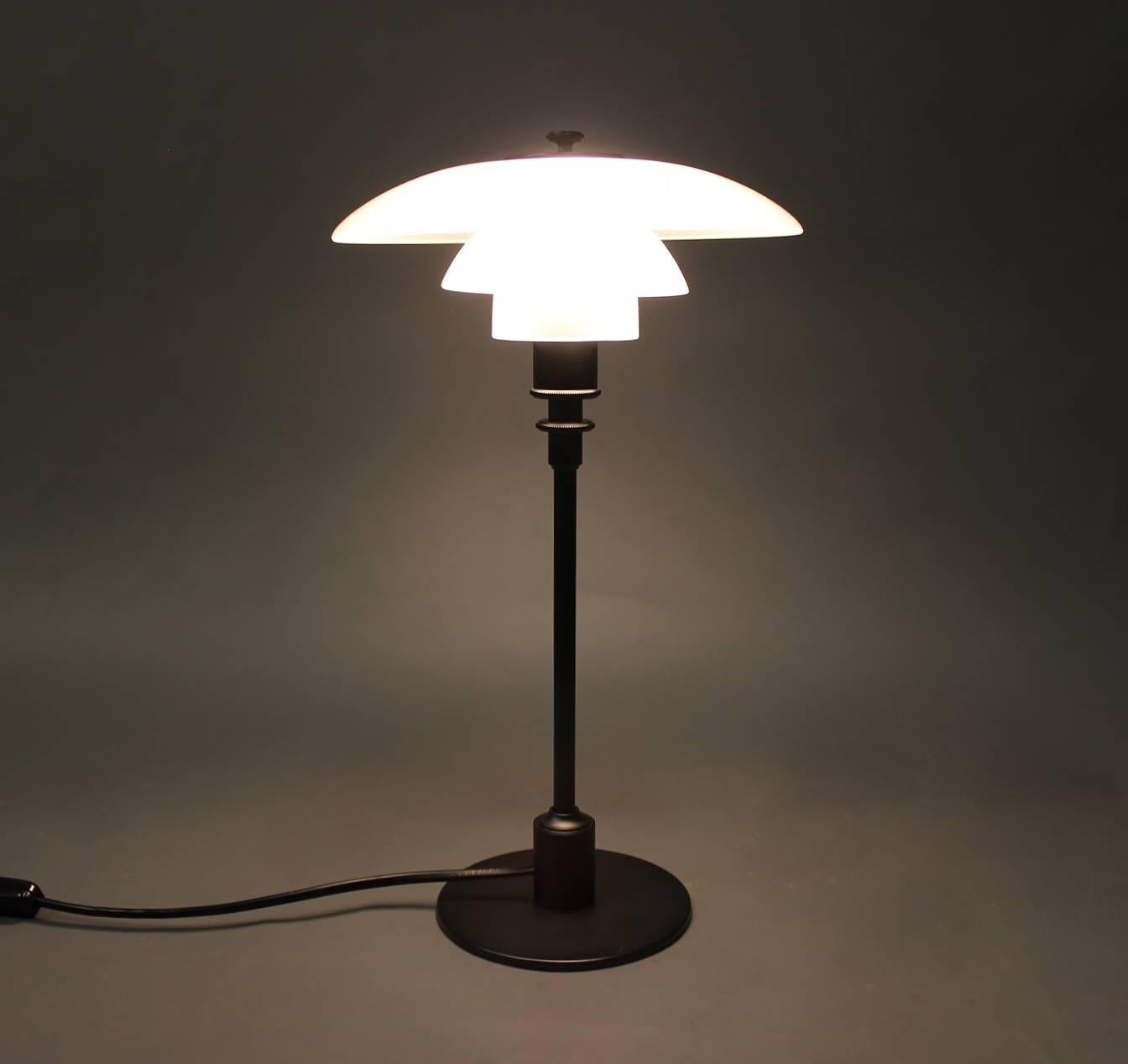 PH 2/1 table lamp, anniversary model, designed by Poul Henningsen and manufactured by Louis Poulsen, 2010s. The lamp is with shades of matte opaline glass and black lacquered frame.