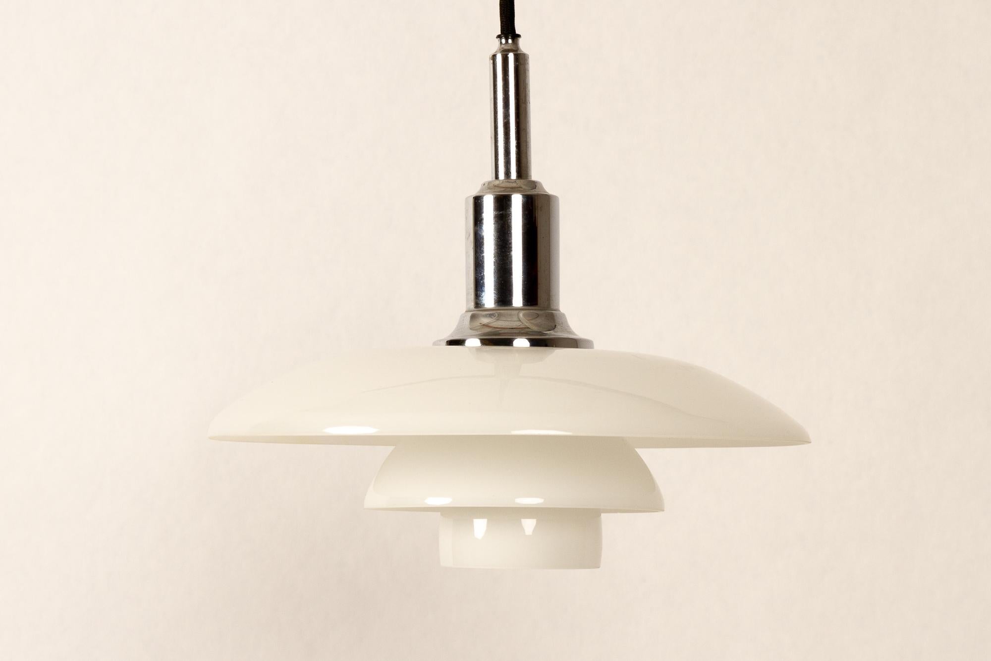 PH 3/2 pendant by Poul Henningsen for Louis Poulsen, 1990s.
Danish PH 3 / 2 pendant with three opaline glass shades, top in chrome-plated brass. Iconic lamps designed in the 1920s by Danish architect Poul Henningsen. All lamps are glare free, and