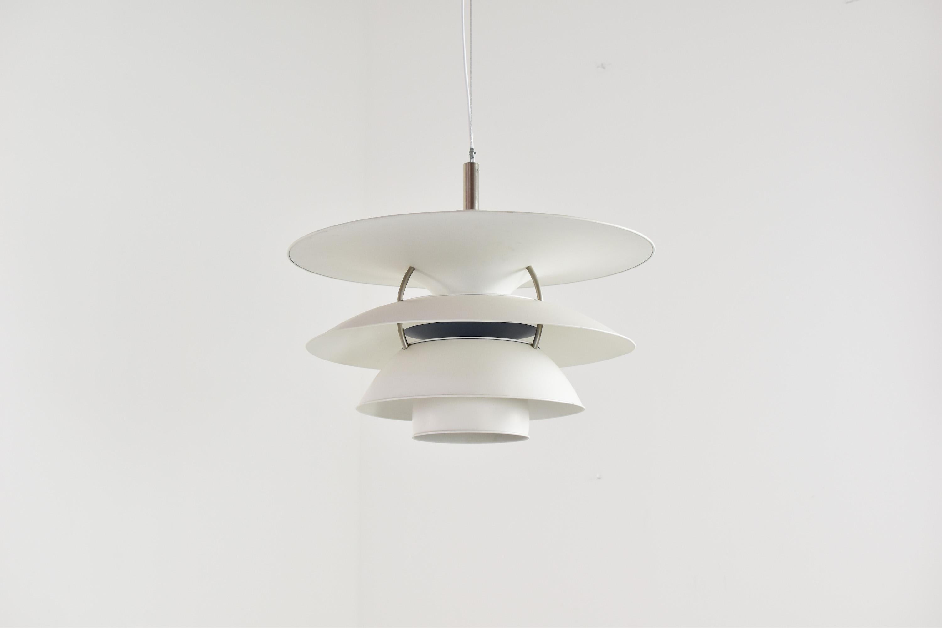 Lovely PH 6½-6 pendant by Poul Henningsen for Louis Poulsen, Denmark 1980’s. This is the largest version and features white lacquered metal shades. Poul Henningsen designed the lamp for the Charlottenborg exhibition building in Copenhagen. Beautiful