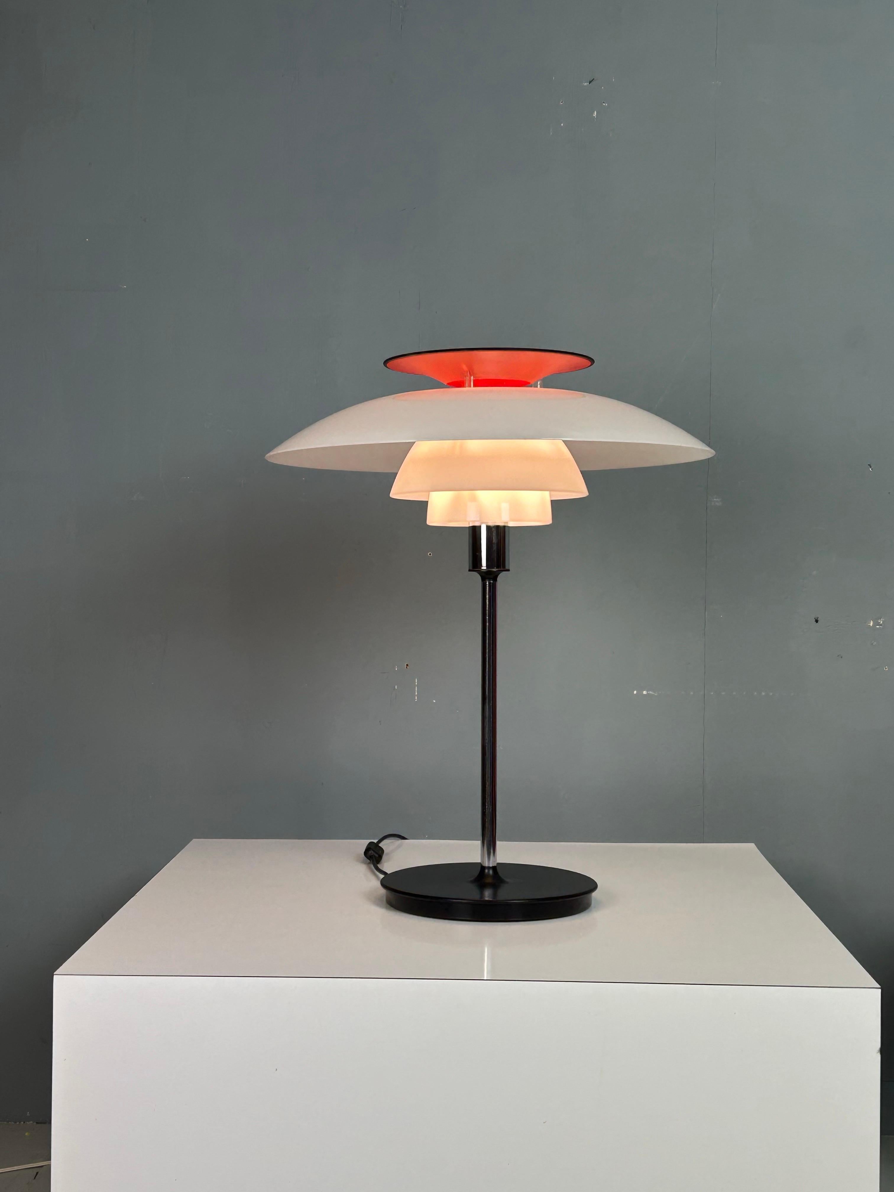 An iconic PH 80 table lamp, designed by Poul Henningsen and produced by Louis Poulsen in Denmark around 1970. Part of the legendary PH lighting series, the lamp embodies Henningsen’s lifelong quest to create glare-free, evenly distributed