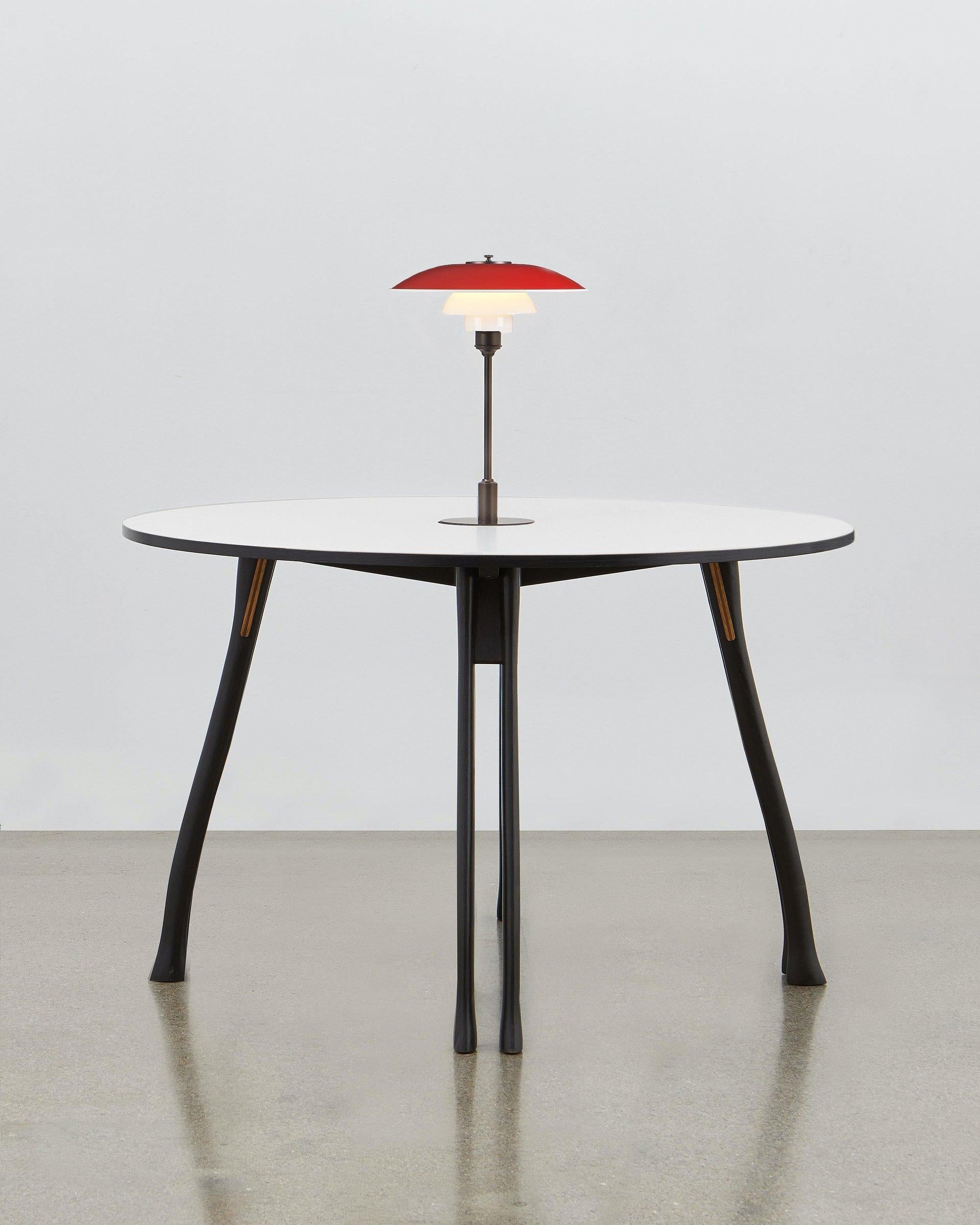 Inspired by the humble axe handle, Poul Henningsen has utilized this familiar and tactile shape to provide the basis for the legs of the versatile table.

This piece of furniture stays true to the fundamental values that drove its designer: it is