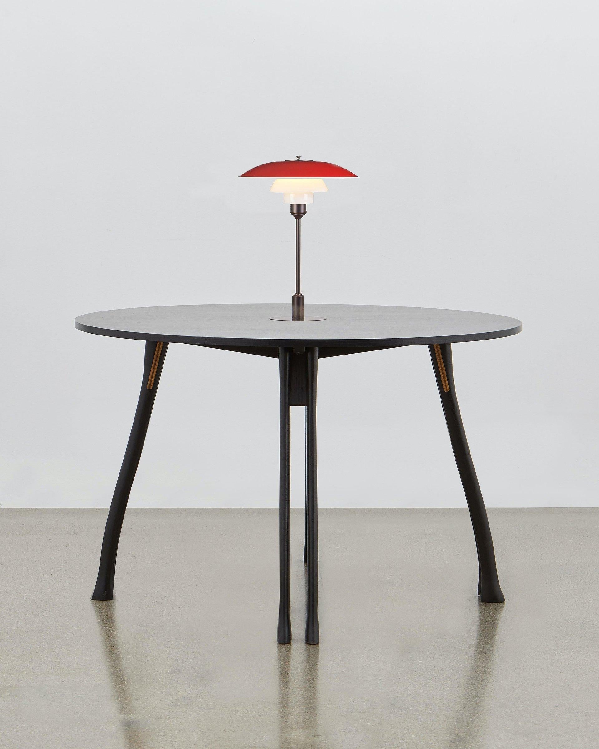 Inspired by the humble axe handle, Poul Henningsen has utilized this familiar and tactile shape to provide the basis for the legs of the versatile table.

This piece of furniture stays true to the fundamental values that drove its designer: it is