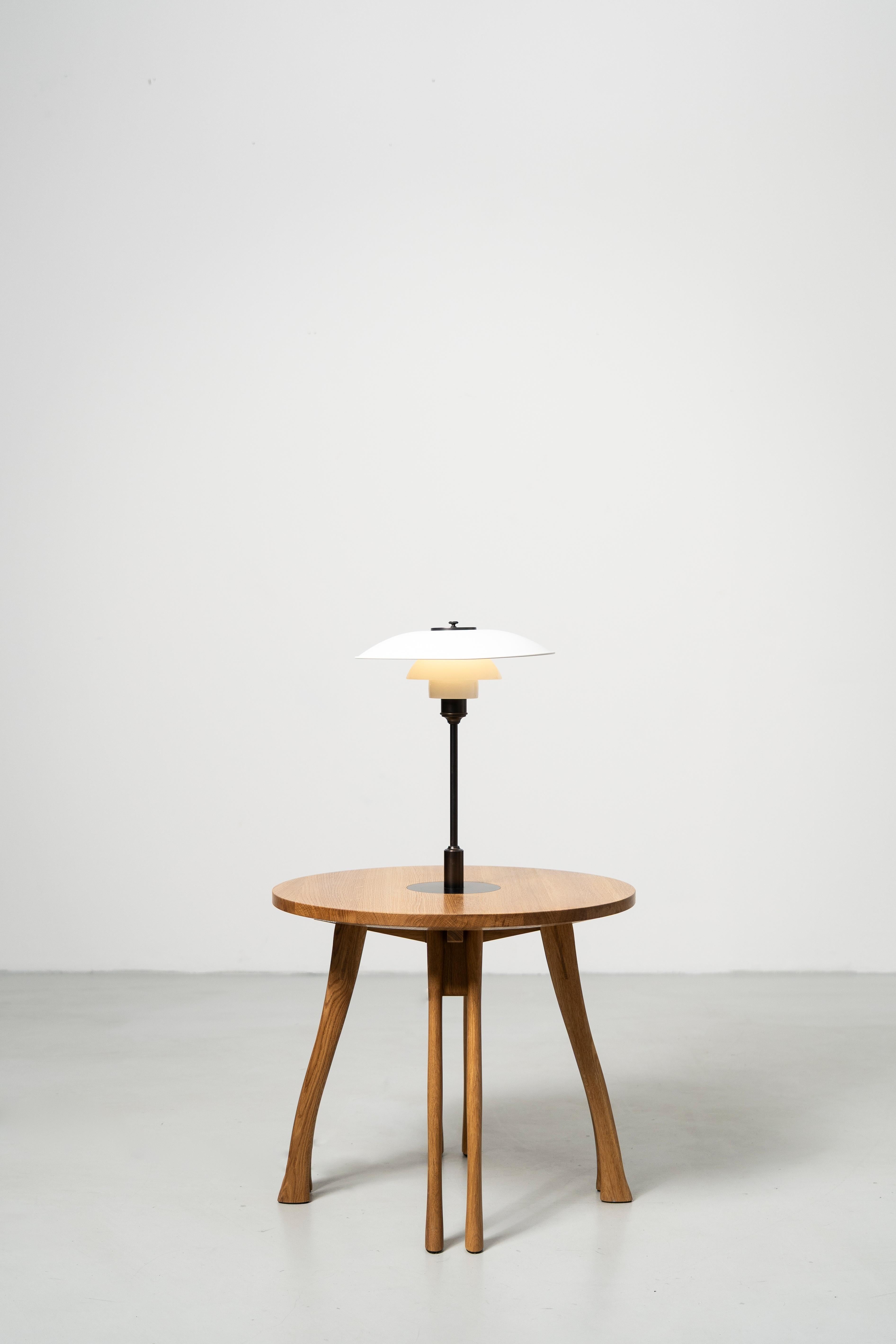 Designed in the first half of the 1950s by Poul Henningsen, the Lounge Edition translates the tactile profile of an axe handle into eight solid oak legs calm strength with a light visual stance. 

Two sizes at staggered lounge heights let the tables