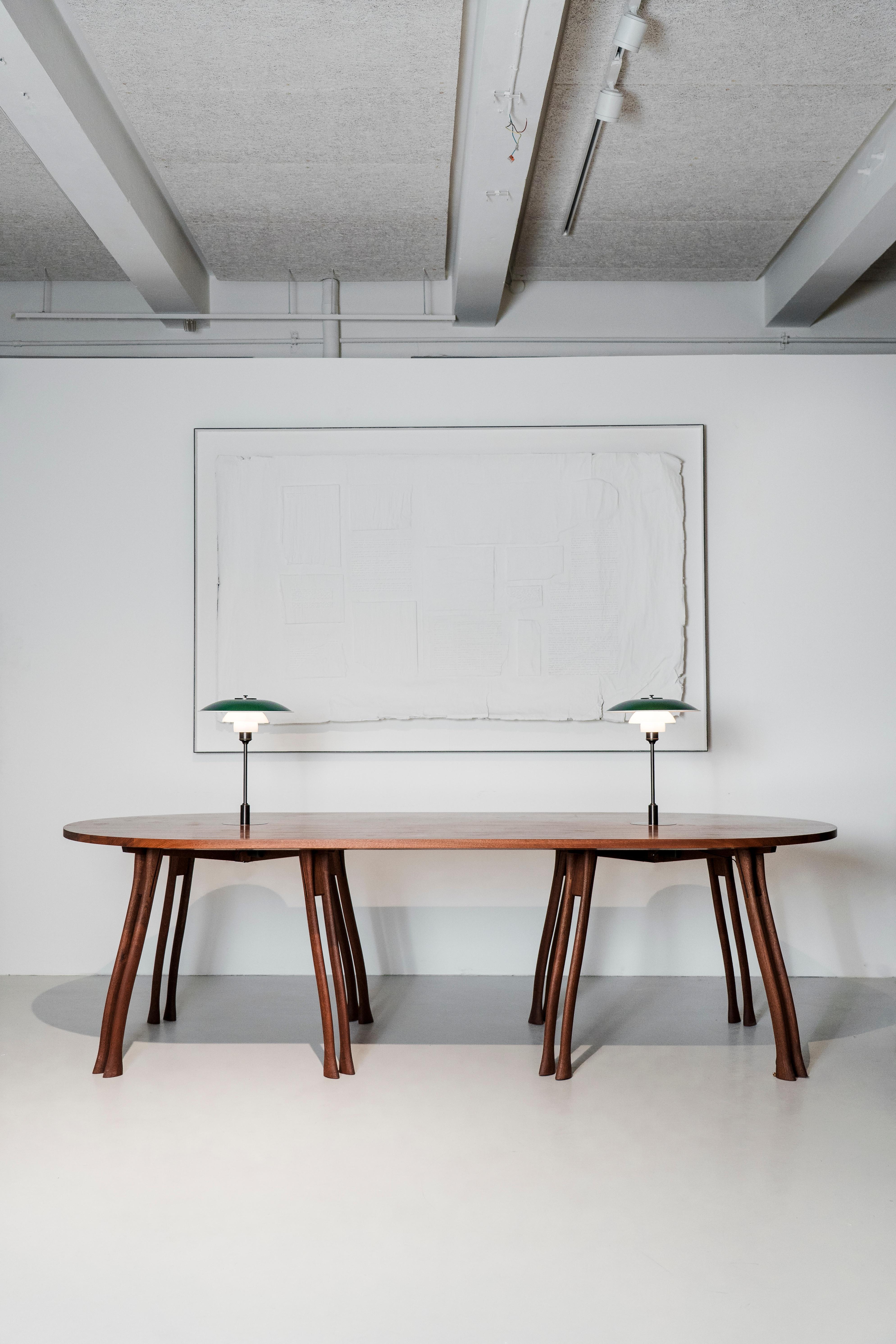 Designed in the early 1950s by Poul Henningsen, the PH Board Table
translates the tactile profile of an axe handle into sturdy, sculpted legs. A
versatile surface for meetings, dining, work and display, it combines a
calm outline with everyday