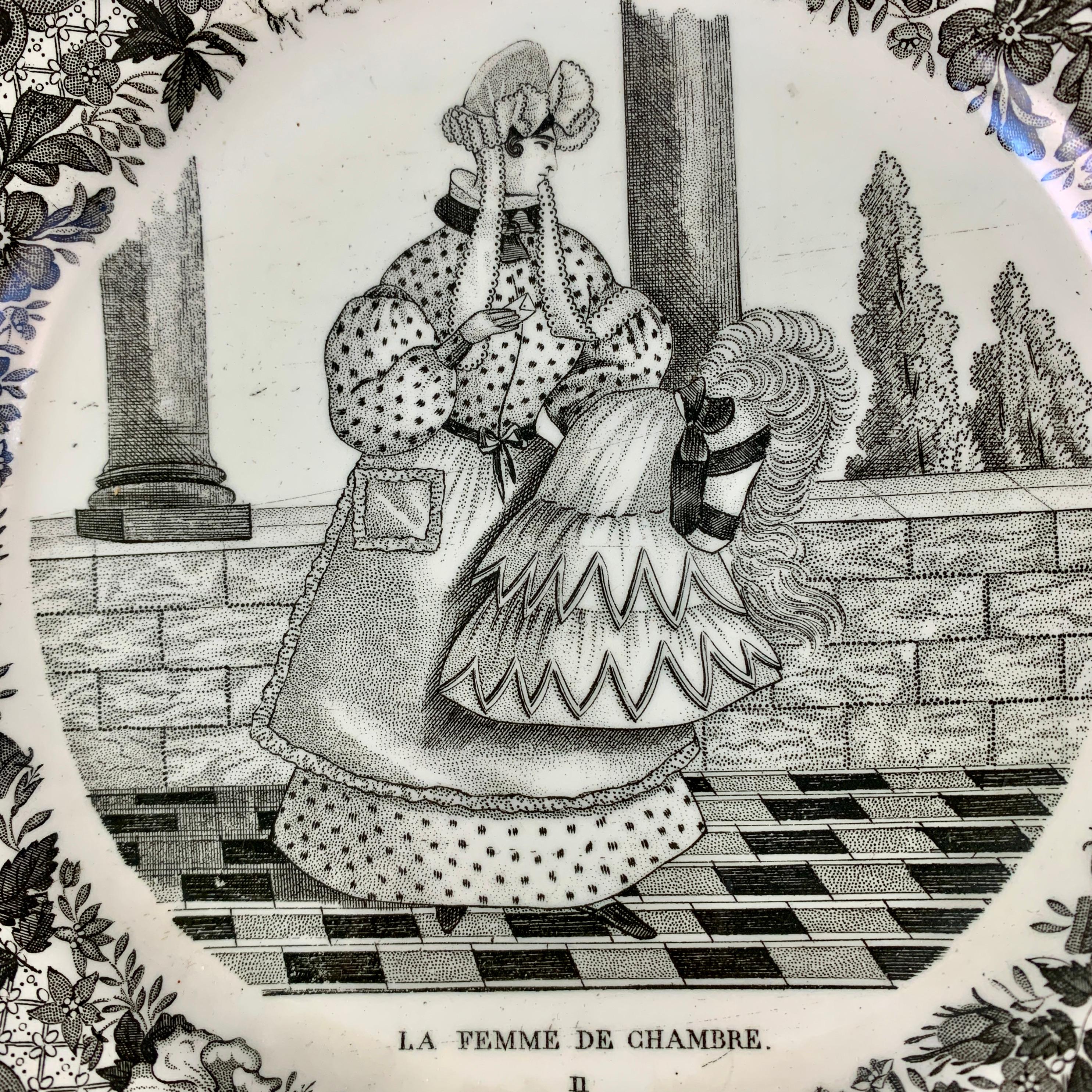 Une assiette parlante en faïence française, produite par P&H Choisy, Seine, France - vers 1824-1836.

Transfert en noir d'une scène de boudoir ; une femme en robe d'époque, debout dans sa chambre. Des carreaux de sol géométriques, des colonnes et