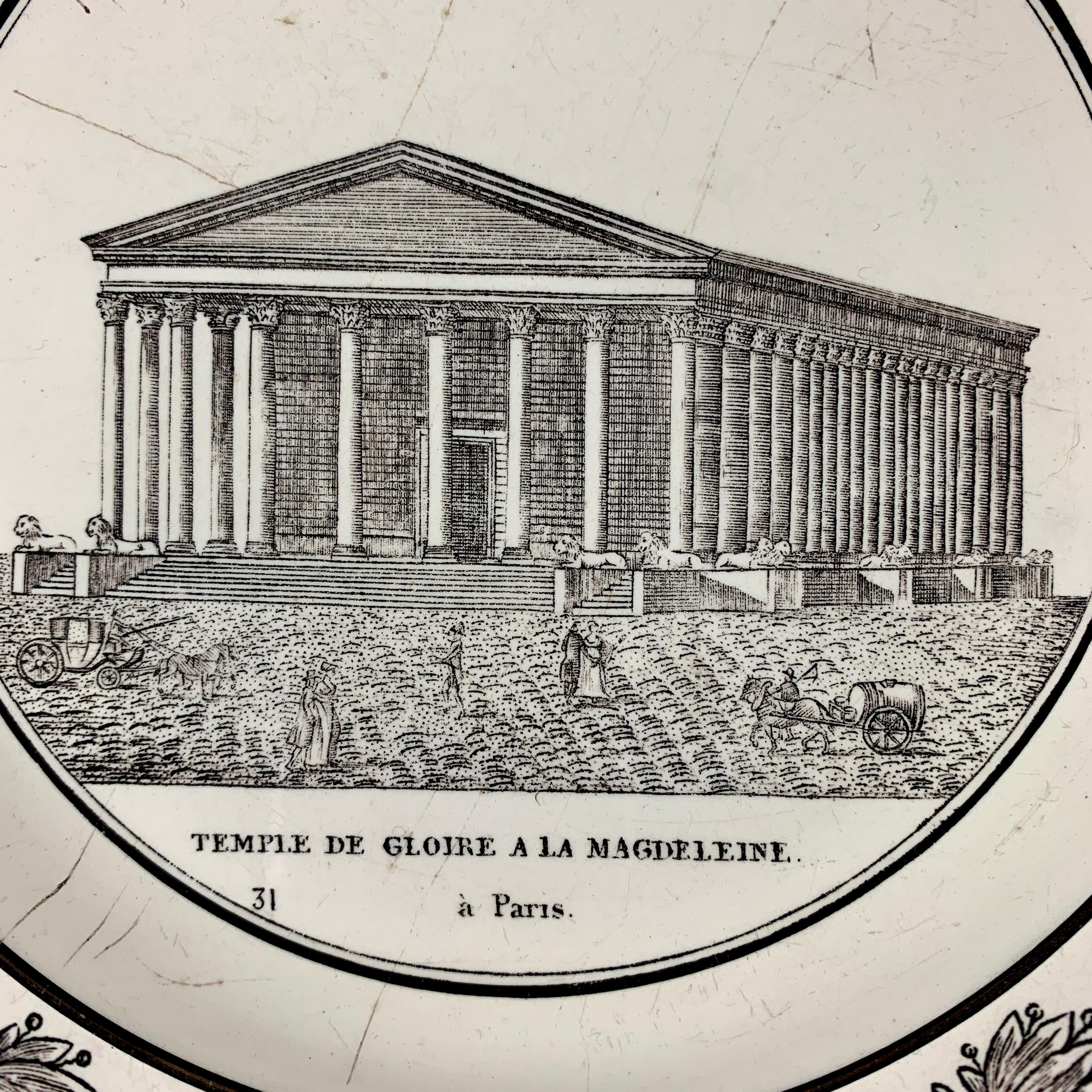 A French Neoclassical faïence transfer printed creamware plate produced by P&H Choisy, circa 1824-1836.

A black transfer of an architectural image on a creamware body, depicting the Temple de Gloire a la Magdeleine à Paris. The Temple is