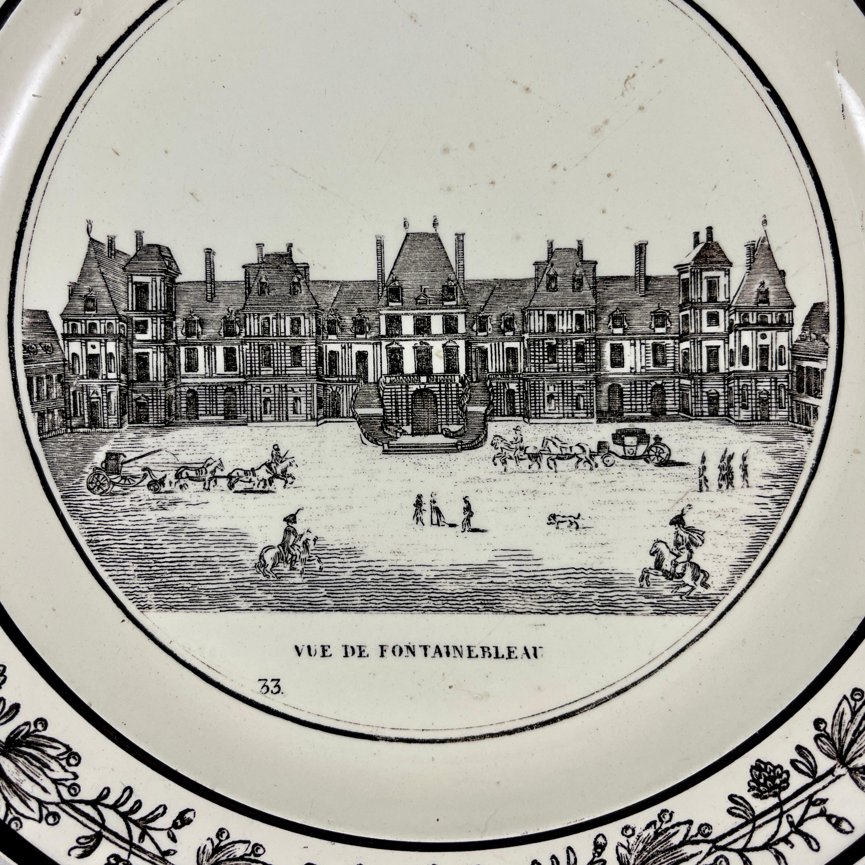 A French Neoclassical faïence transfer printed creamware plate produced by P&H Choisy, circa 1824-1836.

A black transfer of an architectural image on a creamware body, depicting the Vue de Fontainbleu à Paris. The building is prominent, with the