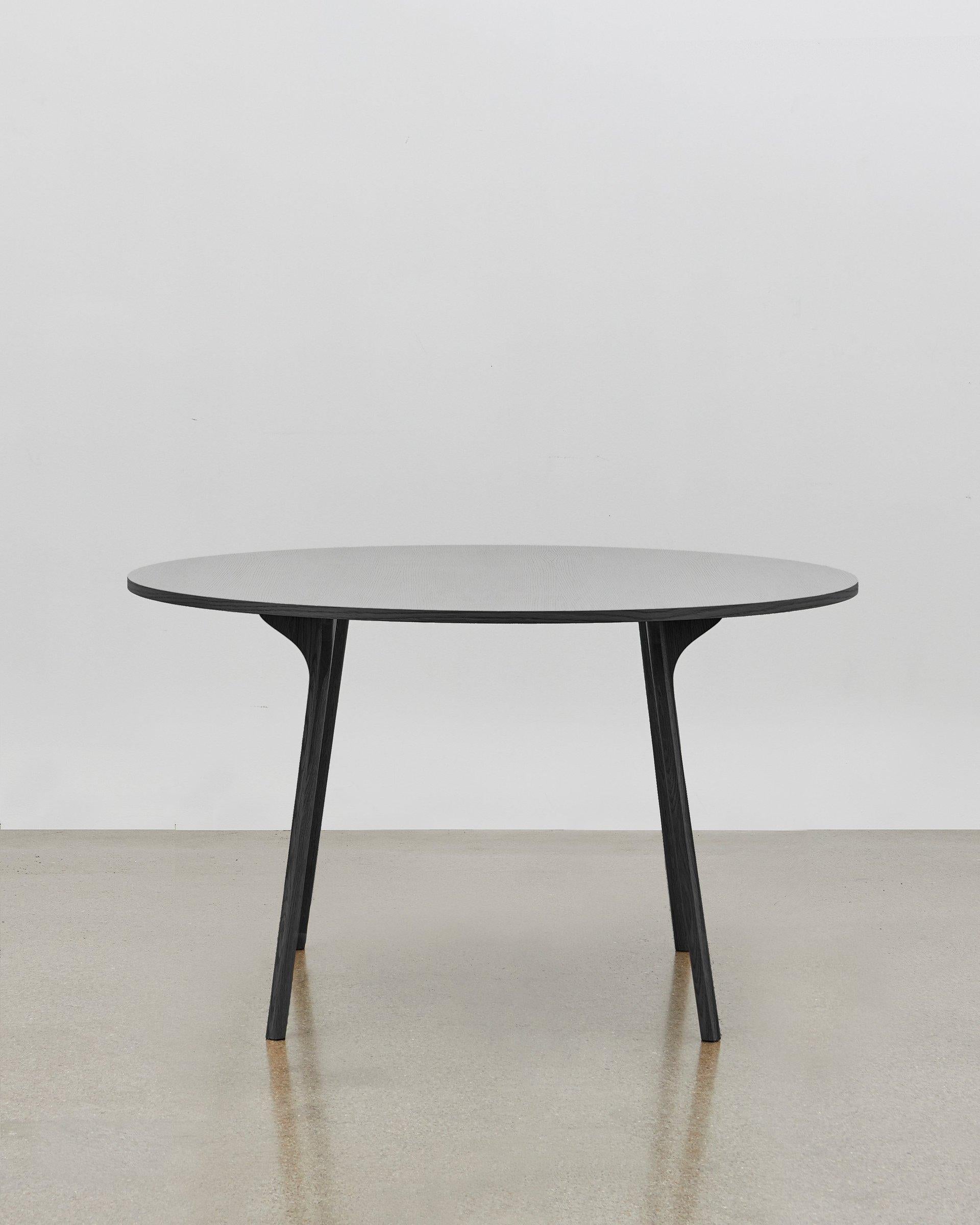 The intricately shaped legs of the PH circle table, inspired by the agile movement of the scarab beetle, together with the benefit of precision design and engineering, enable Poul Henningsen to design a table with the most unobtrusive of legs.