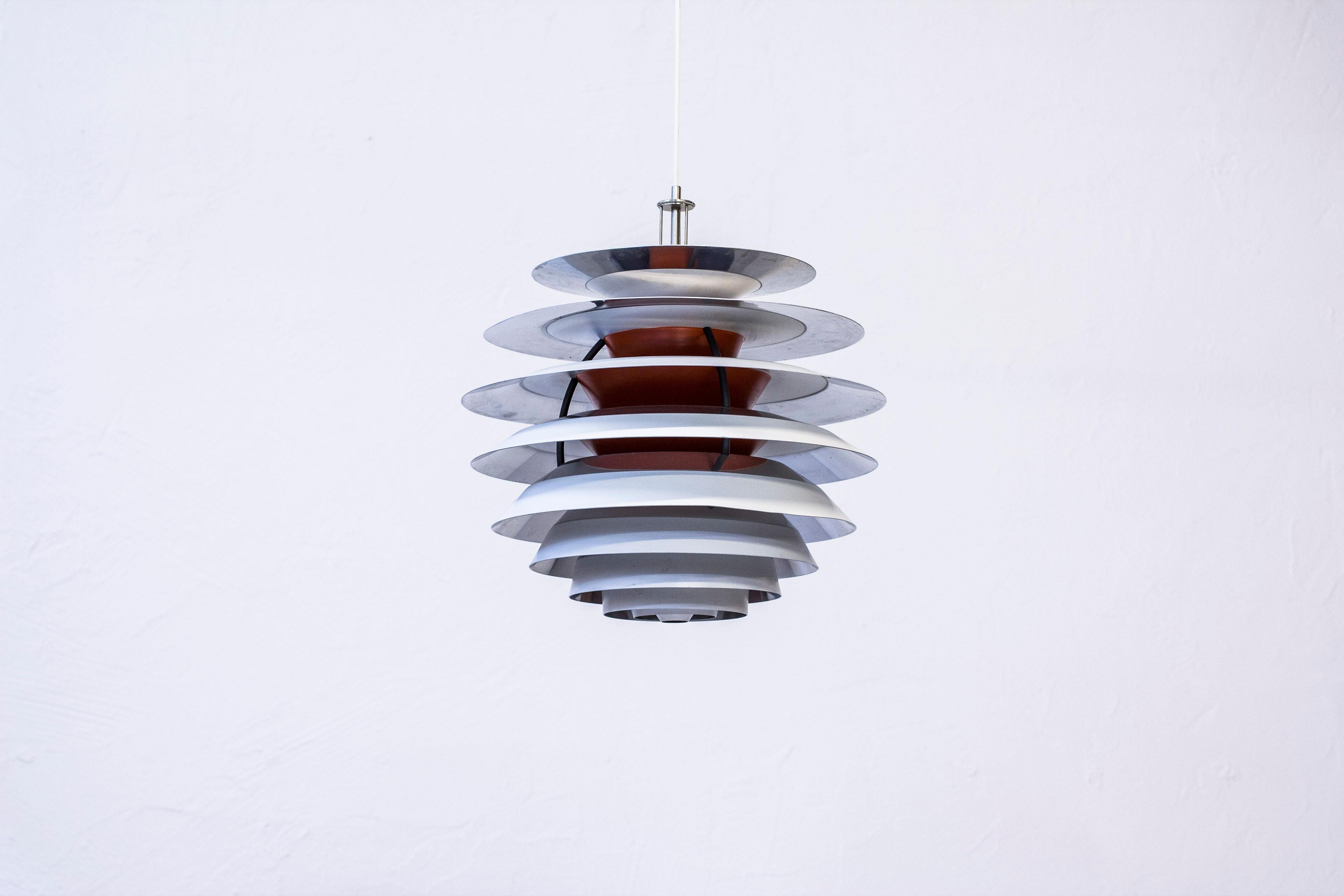 Ceiling lamp model PH Kontrast designed by Poul Henningsen in 1962. This example produced by Louis Poulsen during the 1970s. Excellent condition with light signs of wear and patina. Signed with label.
 